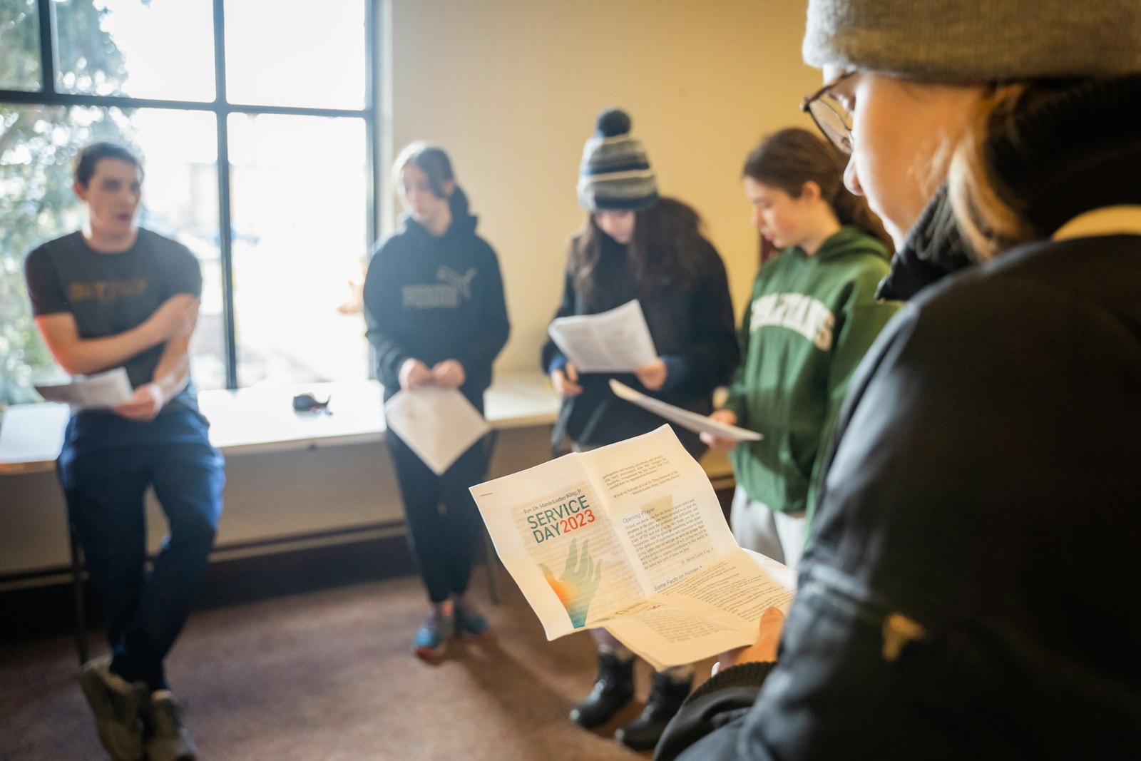 Teens from the National Shrine of the Little Flower Basilica took to the neighborhoods for their service project, collecting pantry items and coats for donation. Before going out into the neighborhood, the teens began the day with a prayer in honor of the Rev. King.