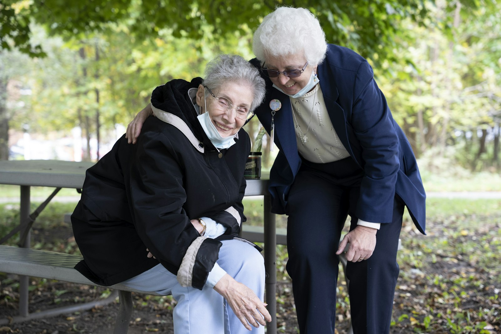 Sr. Magrie and her "agent," Sr. Anne Mamienski, IHM, feed the cats on the IHM Motherhouse campus in Monroe.