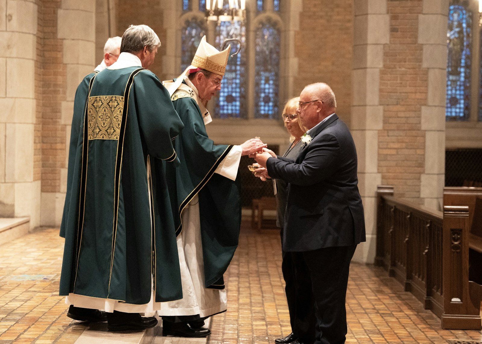 Archbishop Allen H. Vigneron accepts the gifts during a special Mass honoring deacon jubilarians and their wives Oct. 29 at Sacred Heart Major Seminary.