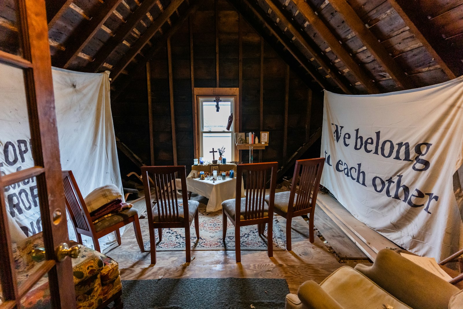 Signs hang throughout the home, which is open to guests, tell visitors about the community's mission.