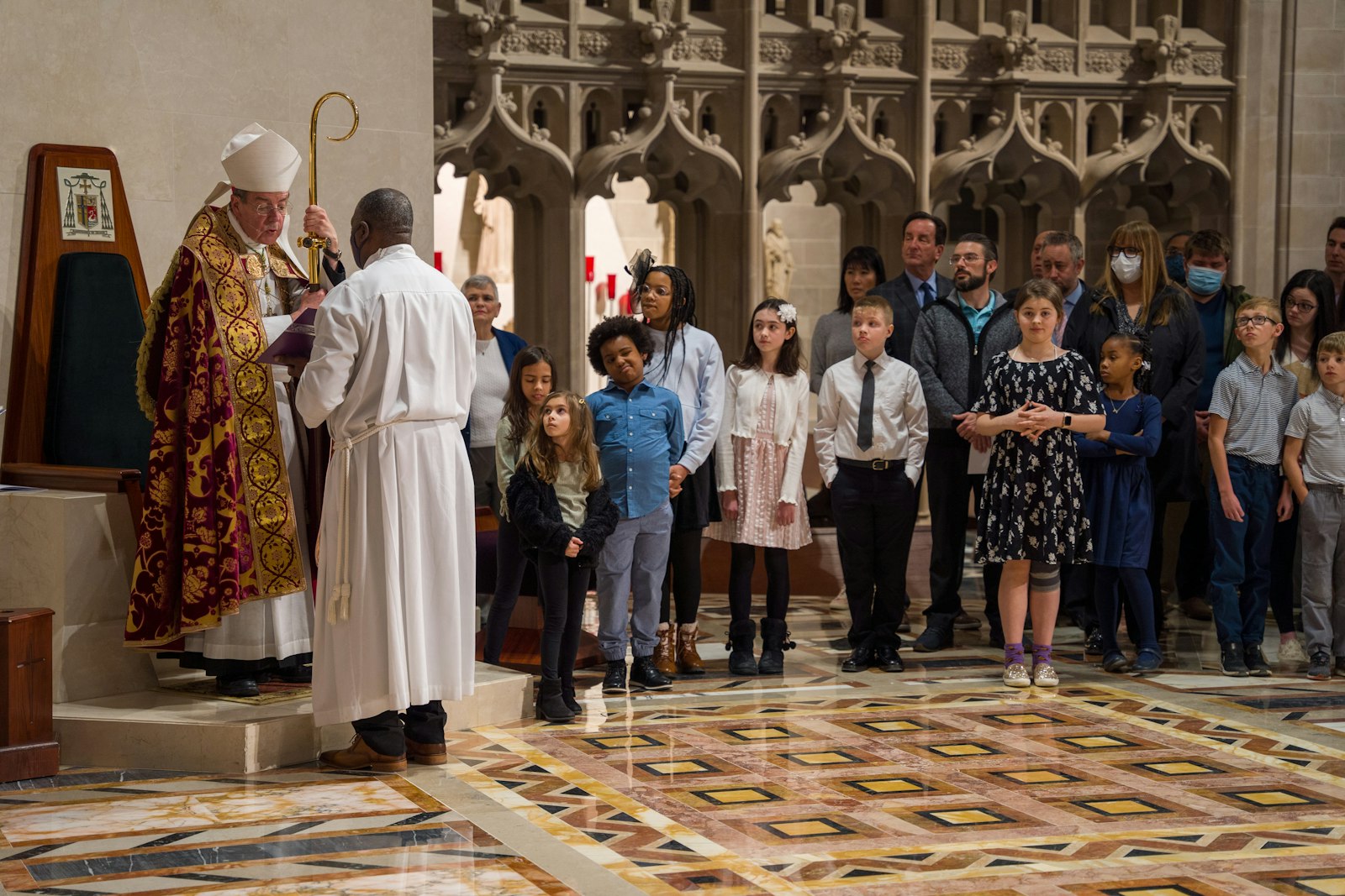 Archbishop Allen H. Vigneron questions catechumens preparing for baptism during the Rite of Election, asking them whether their intent is to follow Jesus in the fullness of the Catholic Church, which he established.