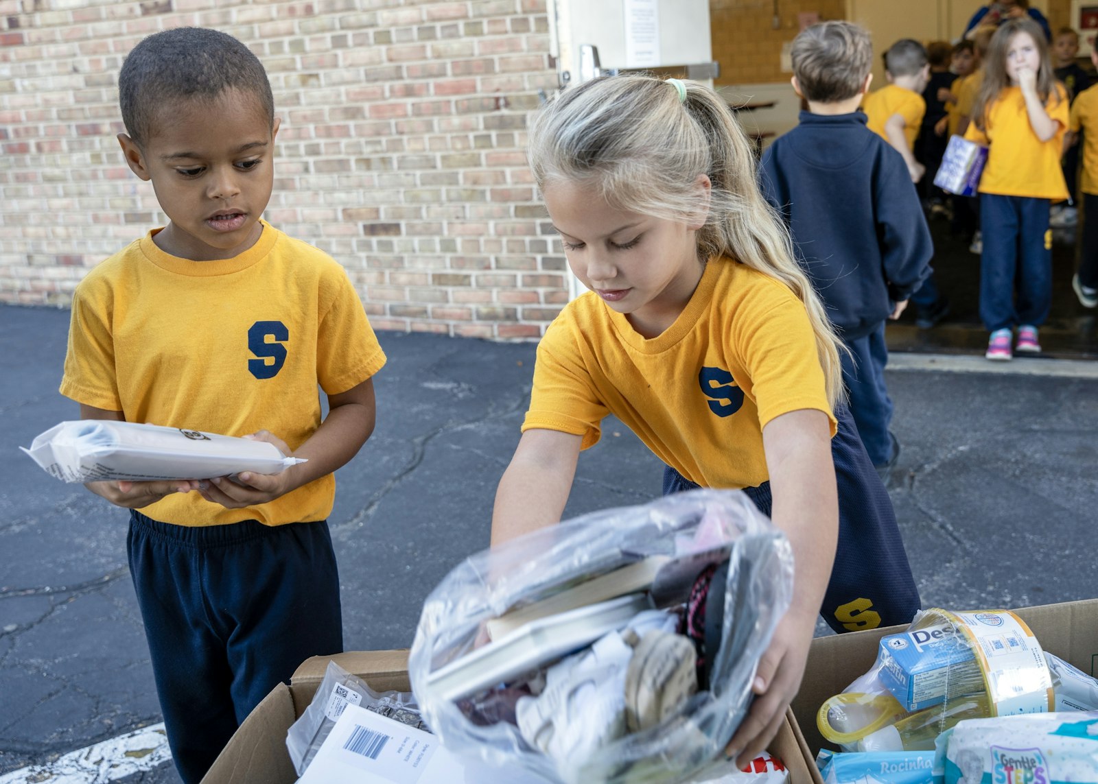 As the school day commenced on Oct. 10, Shrine students, pre-kindergarten through fifth grade, took shifts organized by grade to head down to the cafeteria and load the truck with donations from Shrine school and church members as well as Royal Oak locals.