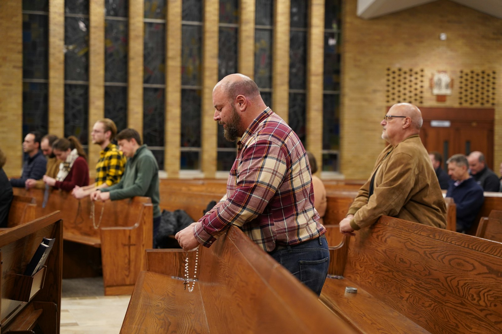 Young adults pray the rosary during a holy hour at Our Lady Queen of Martyrs Parish in Beverly Hills on the eve of the election.