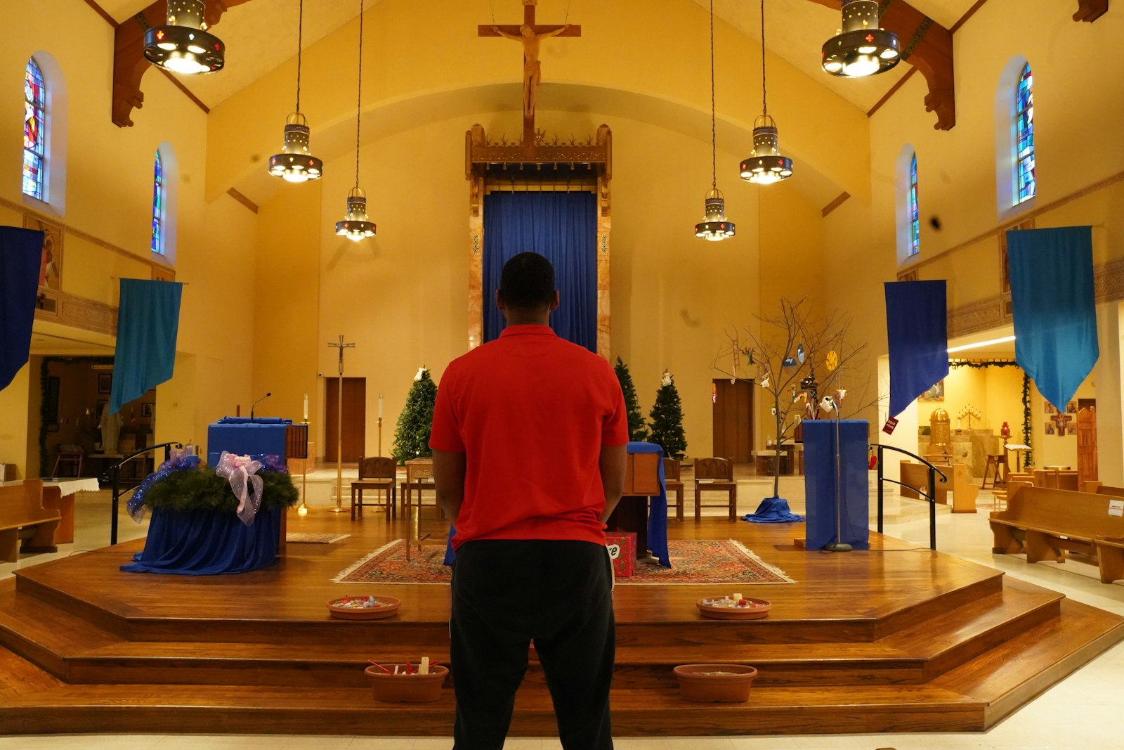 Andrew Jones stands in the sanctuary of Christ the King Parish in Detroit, where he hopes to become a full member of the Catholic faith during the Easter vigil. Jones, who develops young NBA players as the Pistons' director of player development, finds a lot of parallels between his day job and his journey as a member of the faith.