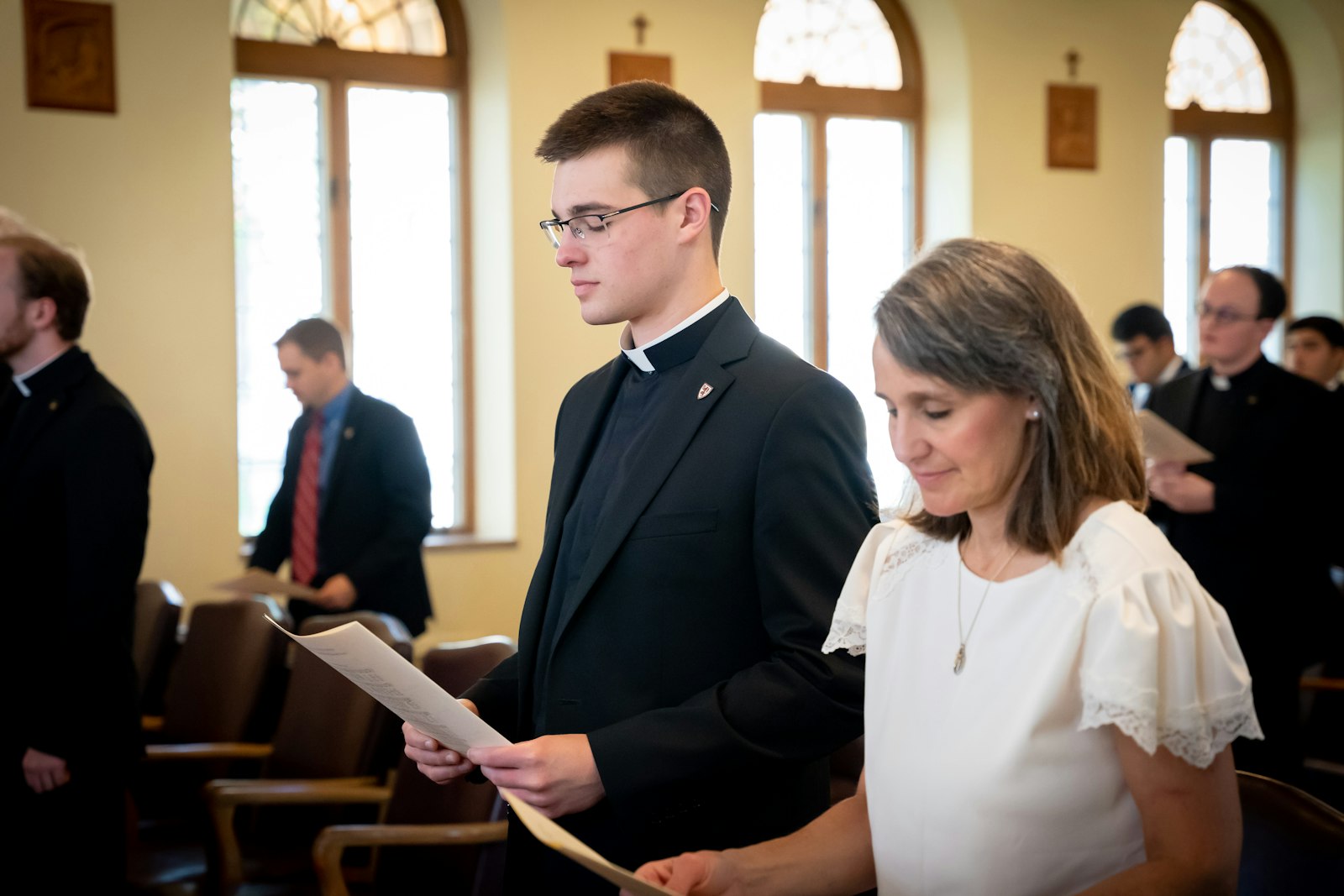 Seminarian Karl Finkbeiner of Our Lady of Good Counsel Parish in Plymouth wears clerics as he and his family pray during the Mass of Candidacy.