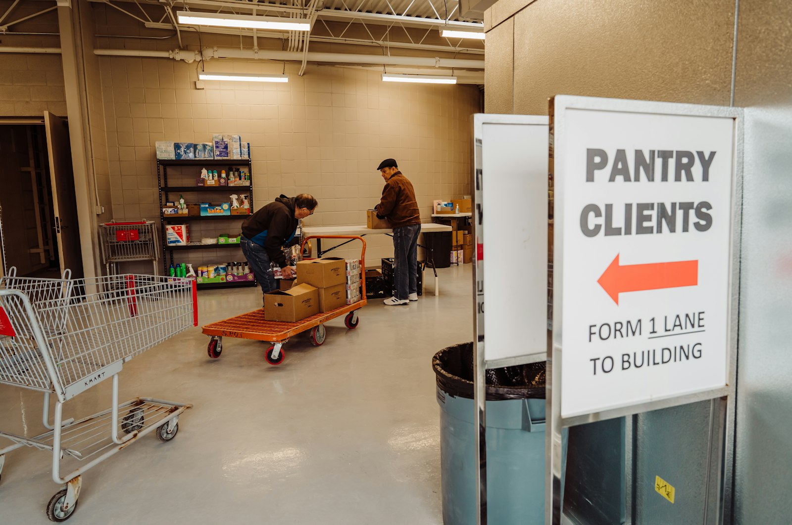 Volunteers unload boxes of food in the parish food pantry at St. Paul of Tarsus Parish in Clinton Township.