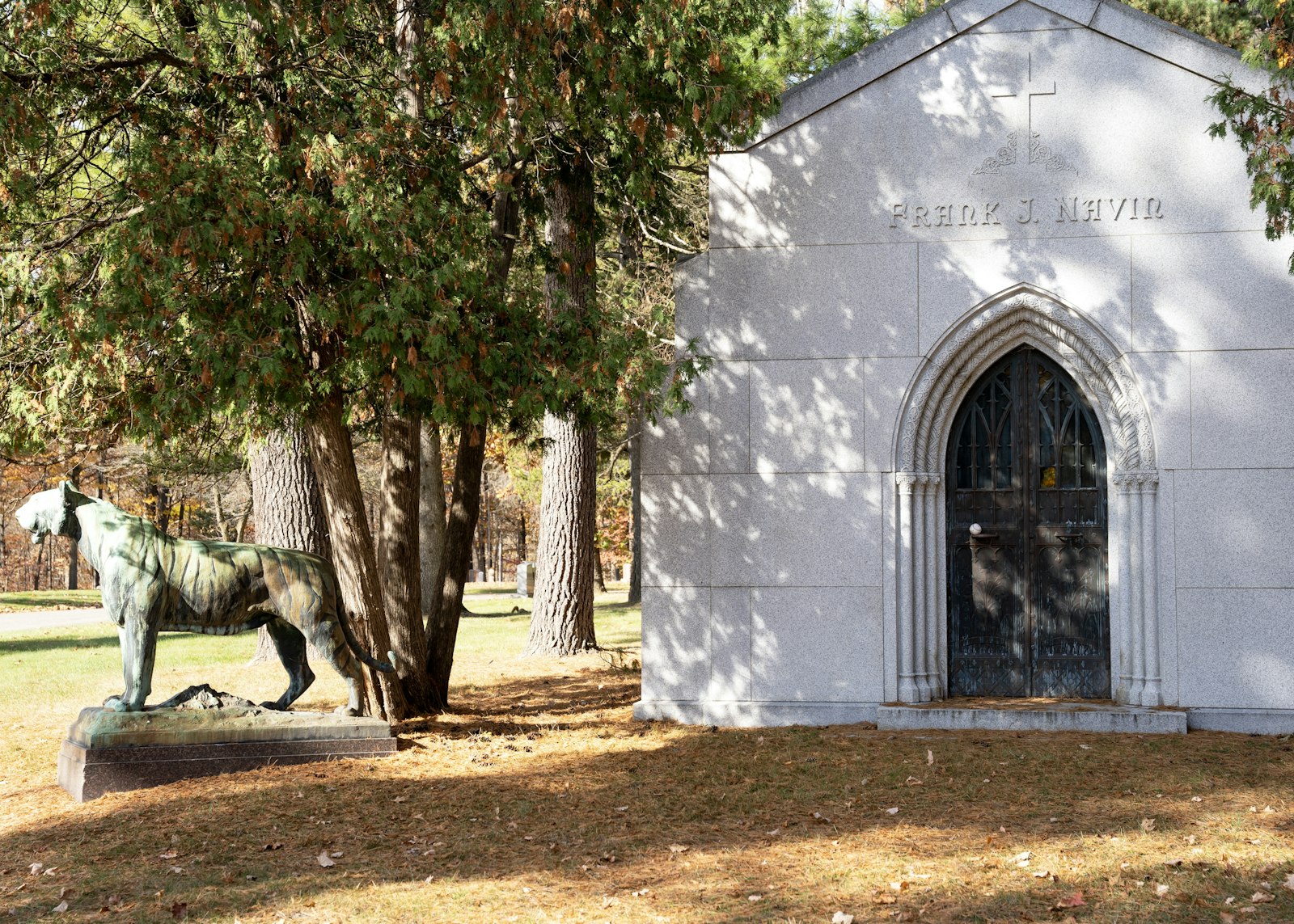 A mausoleum marks the resting place of former Detroit Tigers owner Frank Navin, with a statue of a tiger guarding the spot.