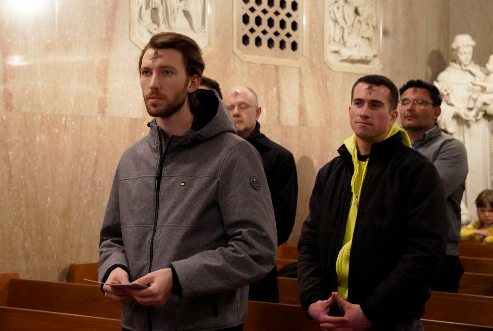 Those who braved the ice and snow to attend Ash Wednesday Mass in downtown Detroit with Archbishop Vigneron wear ashes on their foreheads as they pray on the first day of the Lenten fast.