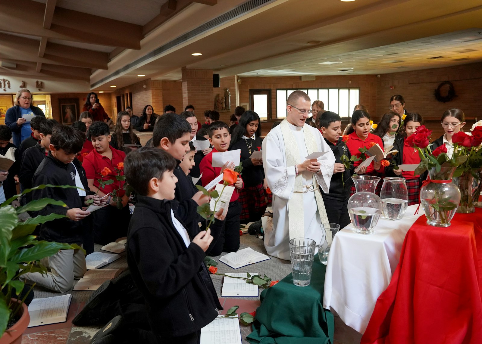 Before they read the consecration prayer and placed roses before her image, Fr. Kurt reminded students that Mary is, in fact, a mother to each of them.