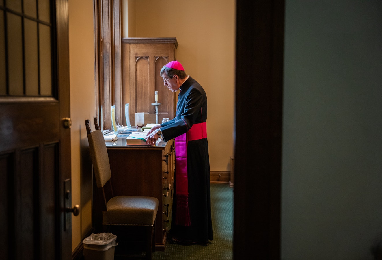 Archbishop Vigneron takes a quiet moment to himself in the sacristy at Sacred Heart Major Seminary while preparing to celebrate the seminary's commencement Mass on April 29, 2023. (Valaurian Waller | Detroit Catholic)