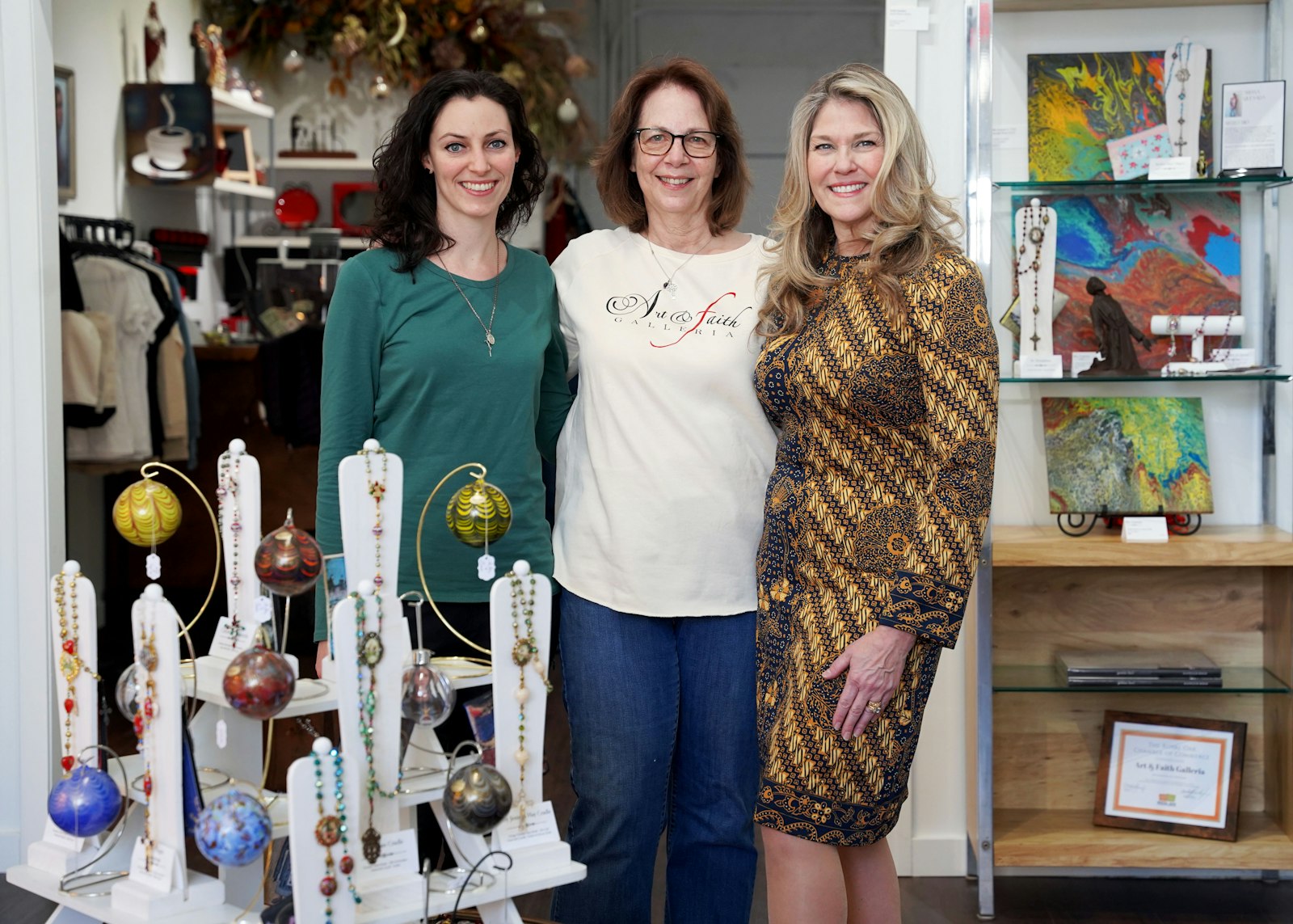 From left to right, artist Mary Dudek, Susan Perrish and Jeannette Quesada stand in the center of the galleria.