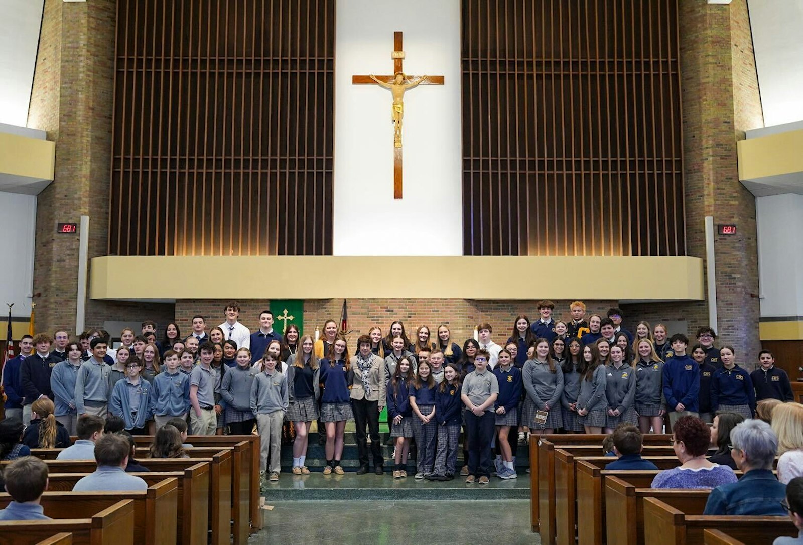 Students, teachers, alumni and those who were taught by Patricia Smolinski gather in the front of St. Frances Cabrini Parish to take a photo with their teacher. A Cabrini alum herself, Smolinski has become an institution in Catholic education in Allen Park.