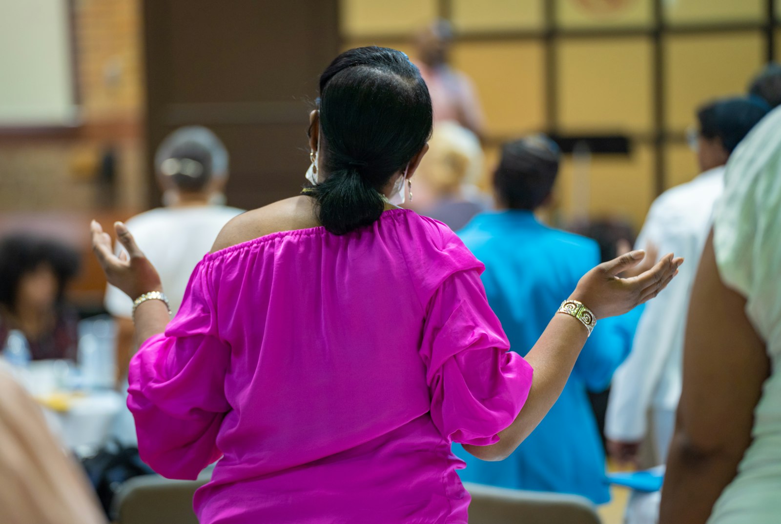 A woman raises her arms in praise during the Black Catholic Women's Conference on Aug. 20 at Sacred Heart Major Seminary in Detroit.