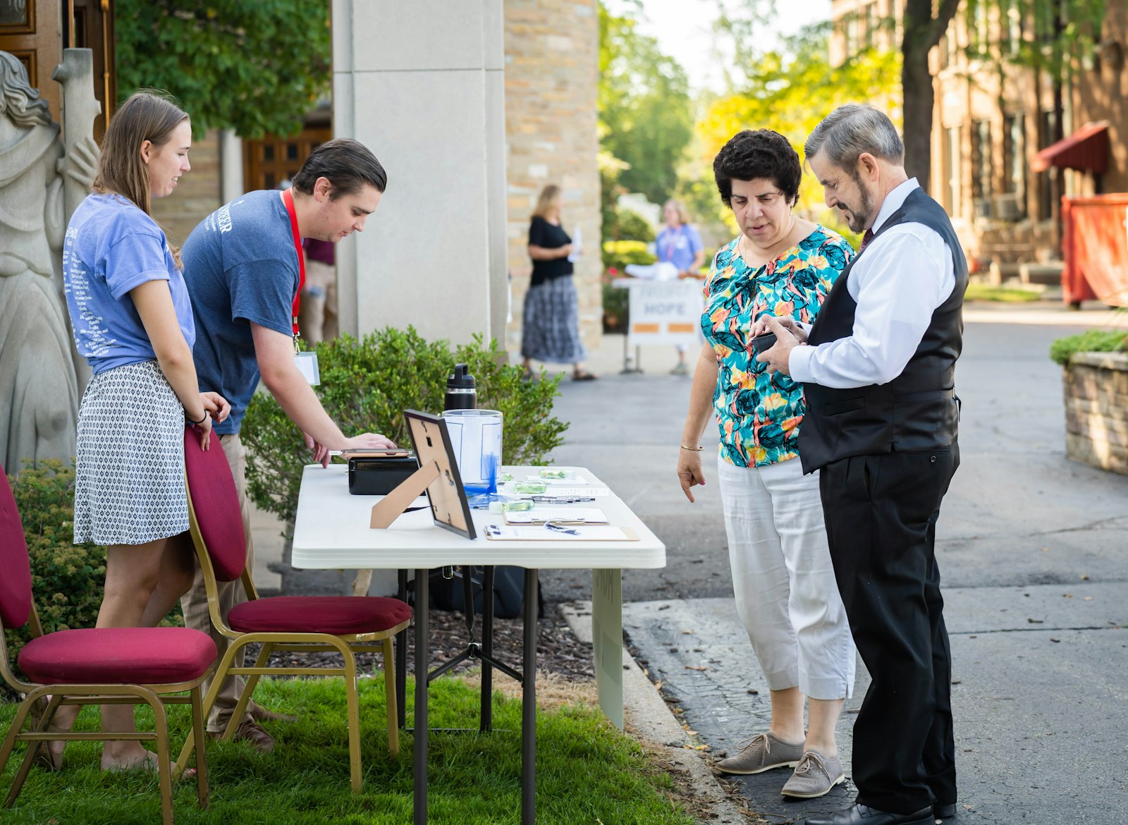 John Vismara and his wife, Michelle, left, speak to parishioners after Mass on Aug. 28 about Project Hope of Michigan, a nonprofit that each year seeks to raise spiritual, financial and moral support for a community member battling cancer. (Valaurian Waller | Detroit Catholic)