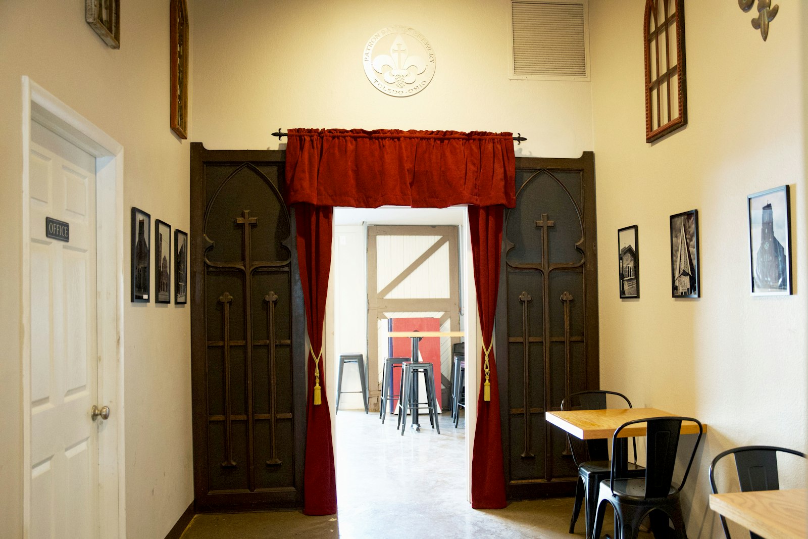 They have a section of the brewery called the "Holy Hallway," which features old repurposed confessional doors and pictures of the local churches. They also have books on saints and saint flashcards for those who wish to learn more.