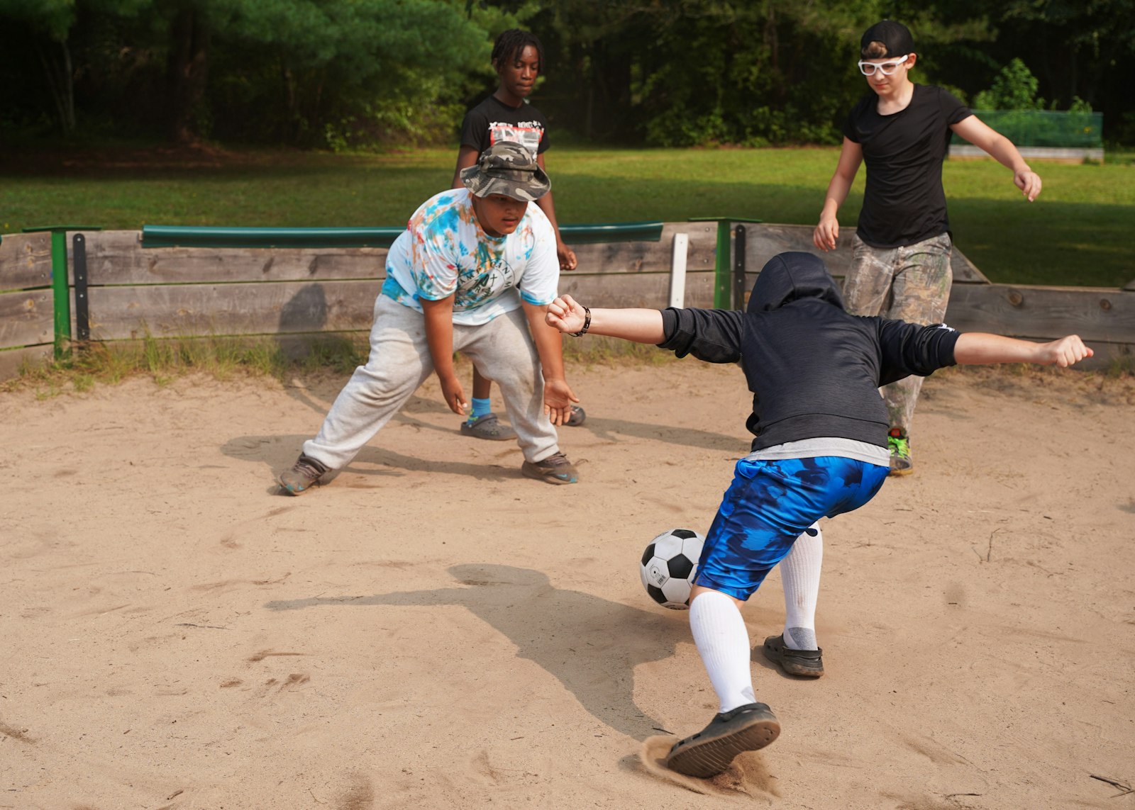 Boys kick a soccer ball around during a game of "GaGa Ball," a camp favorite at Camp Ozanam.