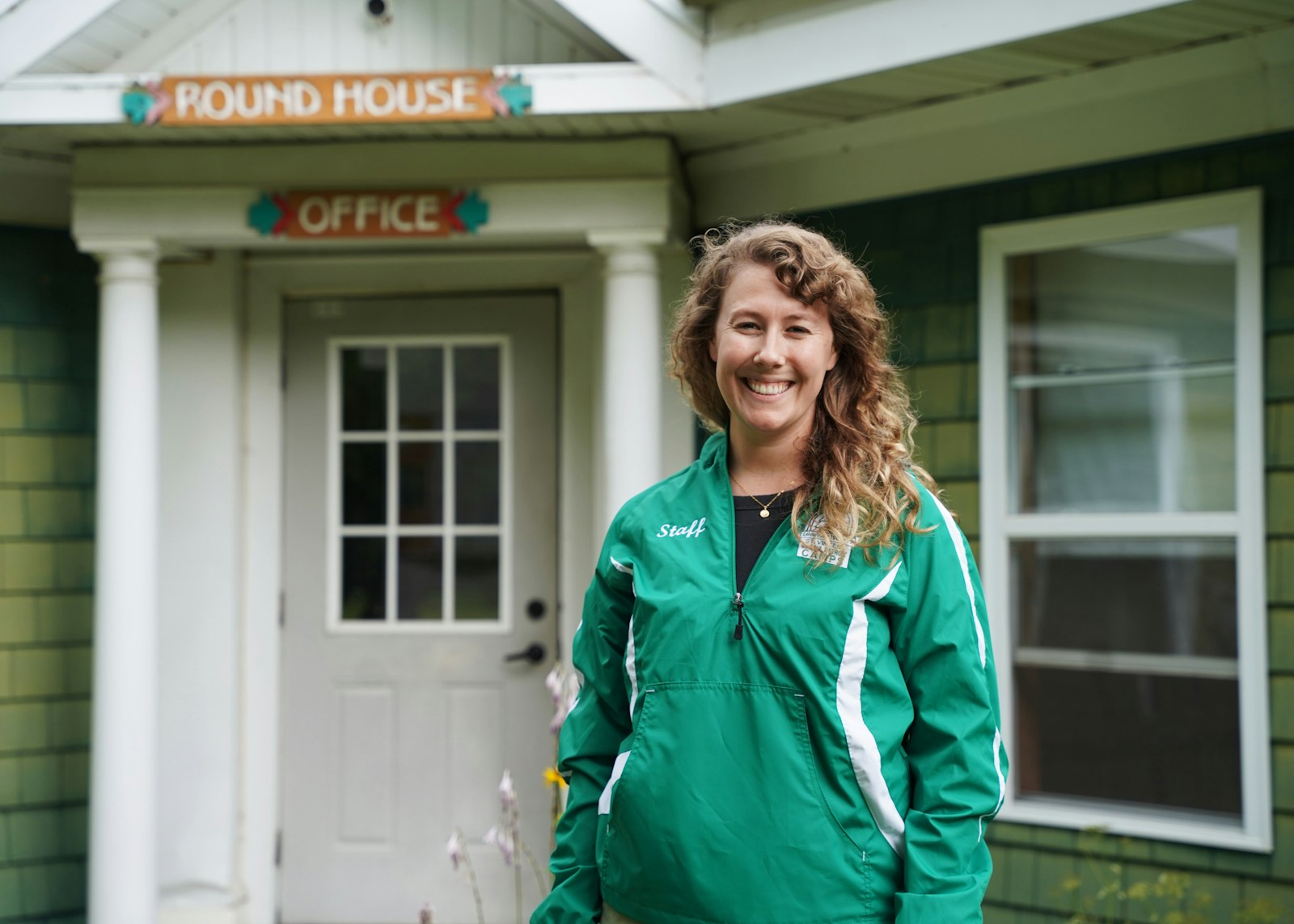 Julia Hohner, director of camp services for the Society of St. Vincent de Paul, Detroit, stands in front of the office at Camp Ozanam, a summer camp for disadvantaged youths near Port Sanilac in Michigan's Thumb.