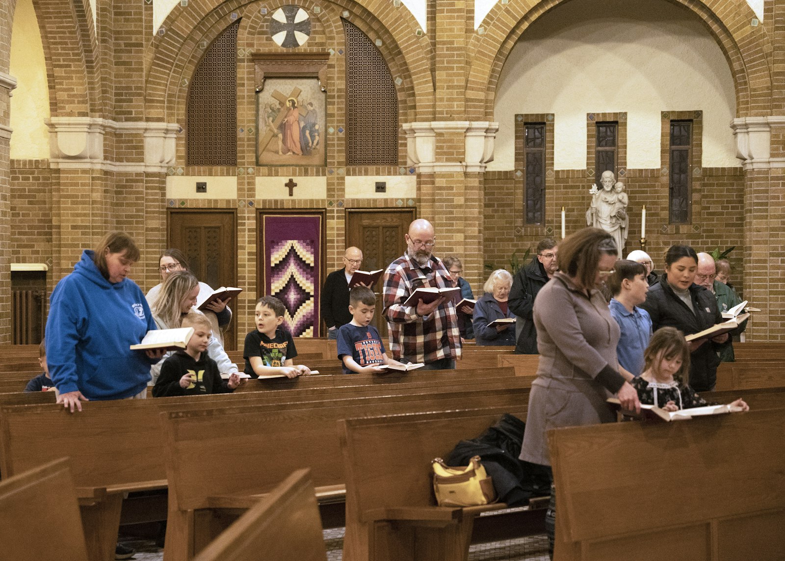 Families pray during a recent children's holy hour at Sacred Heart Parish in Dearborn. (Gabriella Patti | Detroit Catholic)
