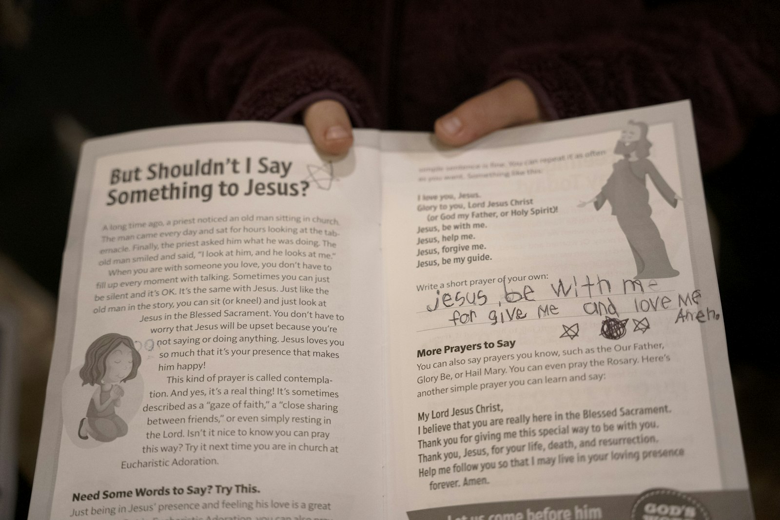 Gemma Henry, age six, told Detroit Catholic that she prayed for her family and friends at school. In her booklet, she was prompted to write a prayer. She wrote: “Jesus, be with me, forgive me and love me. Amen.” (Gabriella Patti | Detroit Catholic)