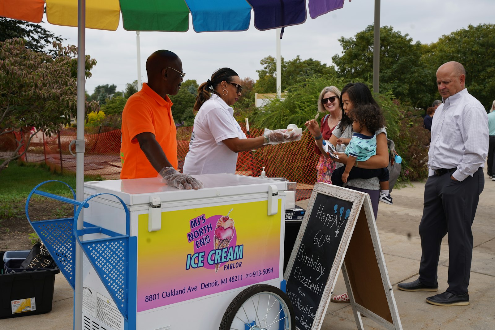 Mark and Anne Justice, both Cathedral of the Most Blessed Sacrament parishioners, and owners of MJ's Northend Parlor, 8801 Oakland Ave., serve up ice cream after Mass, which honored grandparents and elder parishioners.