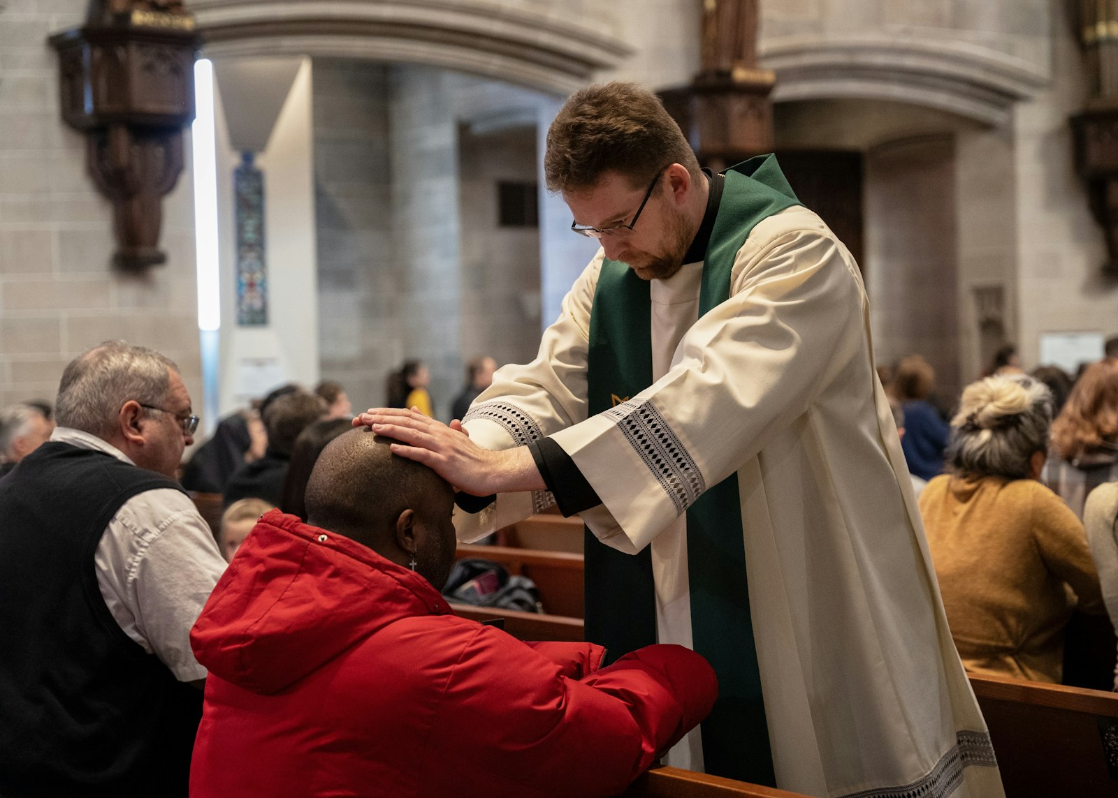 Fr. David Tomaszycki places his hands upon a parishioner's head during the anointing of the sick, one of the sacraments of healing.