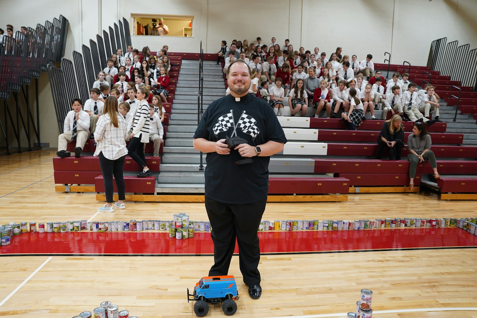 Fr. Andrew Smith of St. Paul on the Lake Parish in Grosse Pointe Farms was the winning driver in the grand prix the school hosted to celebrate how much food it collected. In total, St. Paul on the Lake students collected 5,313 cans and boxes of food. (Daniel Meloy | Detroit Catholic)