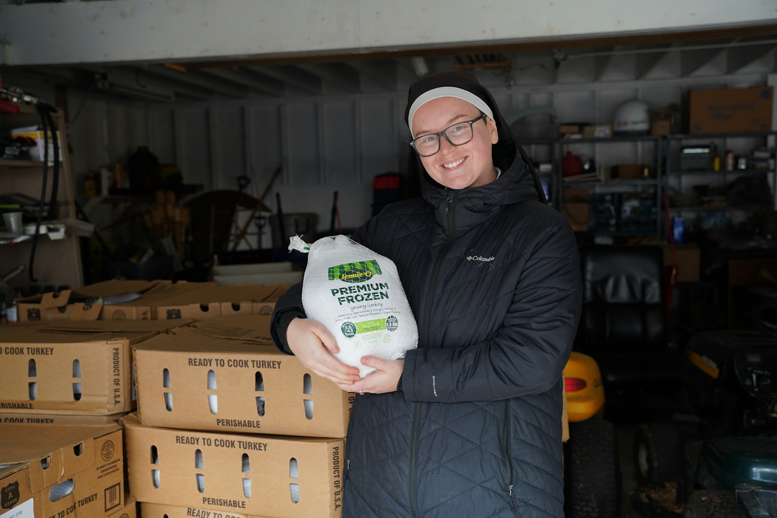 Sr. Piper Klatt of the Sisters of Jesus' Merciful Passion holds up a turkey that was donated Nov. 21 to feed a local family in need. The Sisters organize food drives every Thanksgiving, Christmas and Easter. (Daniel Meloy | Detroit Catholic)