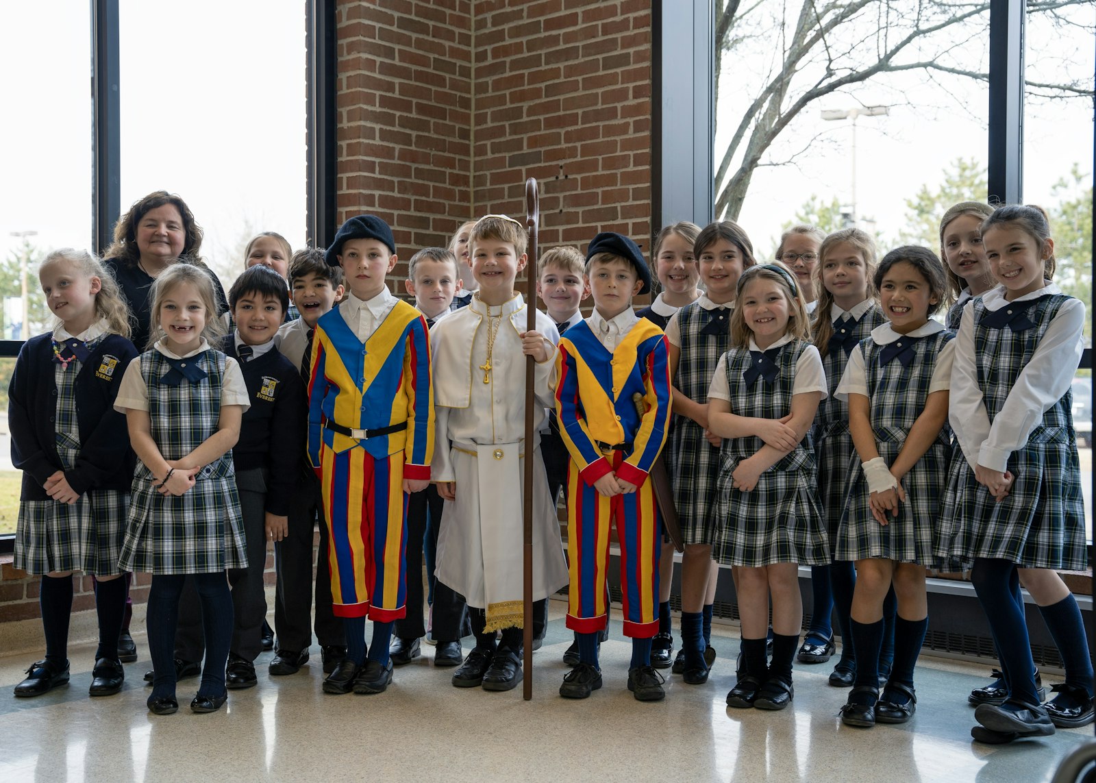 Michelle Wildrick poses with her second-grade class before the pope and his guards head over to the high school, driven by the headmaster in a makeshift popemobile.