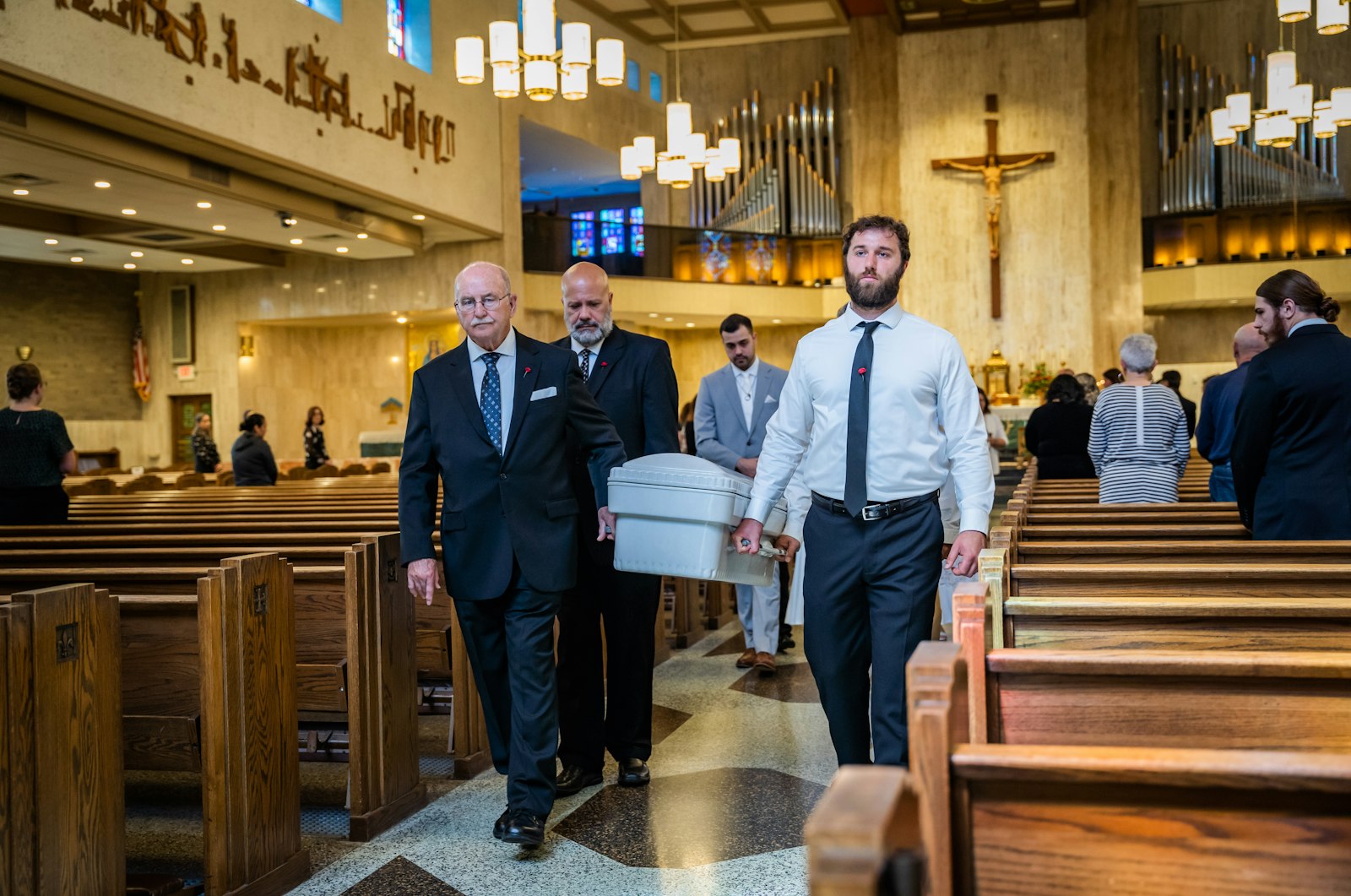 Pallbearers carry the tiny casket of Maria Teresa and Rachel Clare LeBlanc from the Church of the Divine Child to a waiting hearse after the twins' funeral liturgy May 31. (Valaurian Waller | Detroit Catholic)