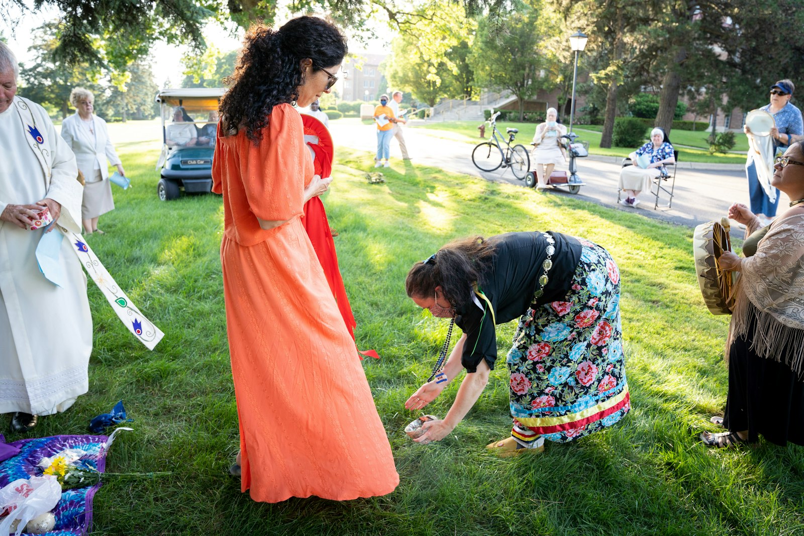 Gros-Louis applies smudge, a type of incense made from sage, to Anita Ruiz during the start of the solstice ceremony. Smudge is used in Native American prayer services much like incense is used during Mass, putting people in a prayerful mood through scent.