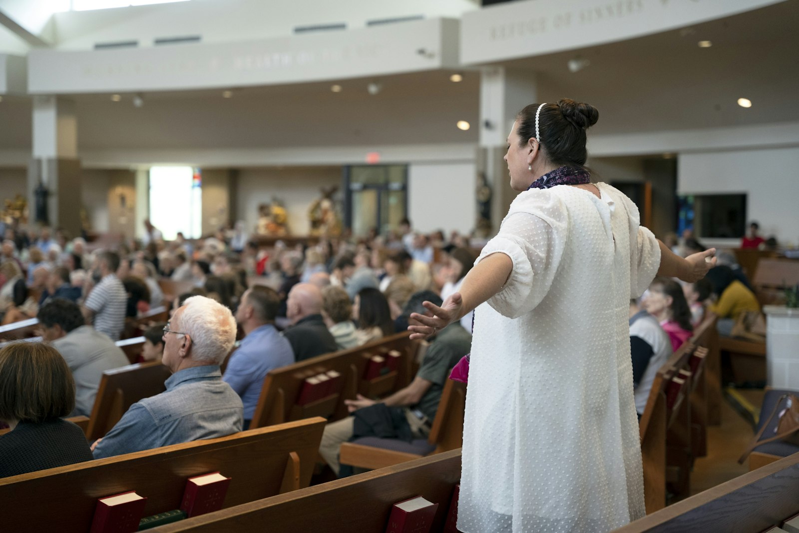 Karen Ervin, associate director of evangelization and discipleship at Our Lady of Good Counsel Parish, worships during the parish's second annual "Praise Fest." Ervin said that the parish staff hopes that the event will deepen the parishioners' love of Christ in the Eucharist and, in turn, inspire them to share it with others outside of the parish. (Gabriella Patti | Detroit Catholic)