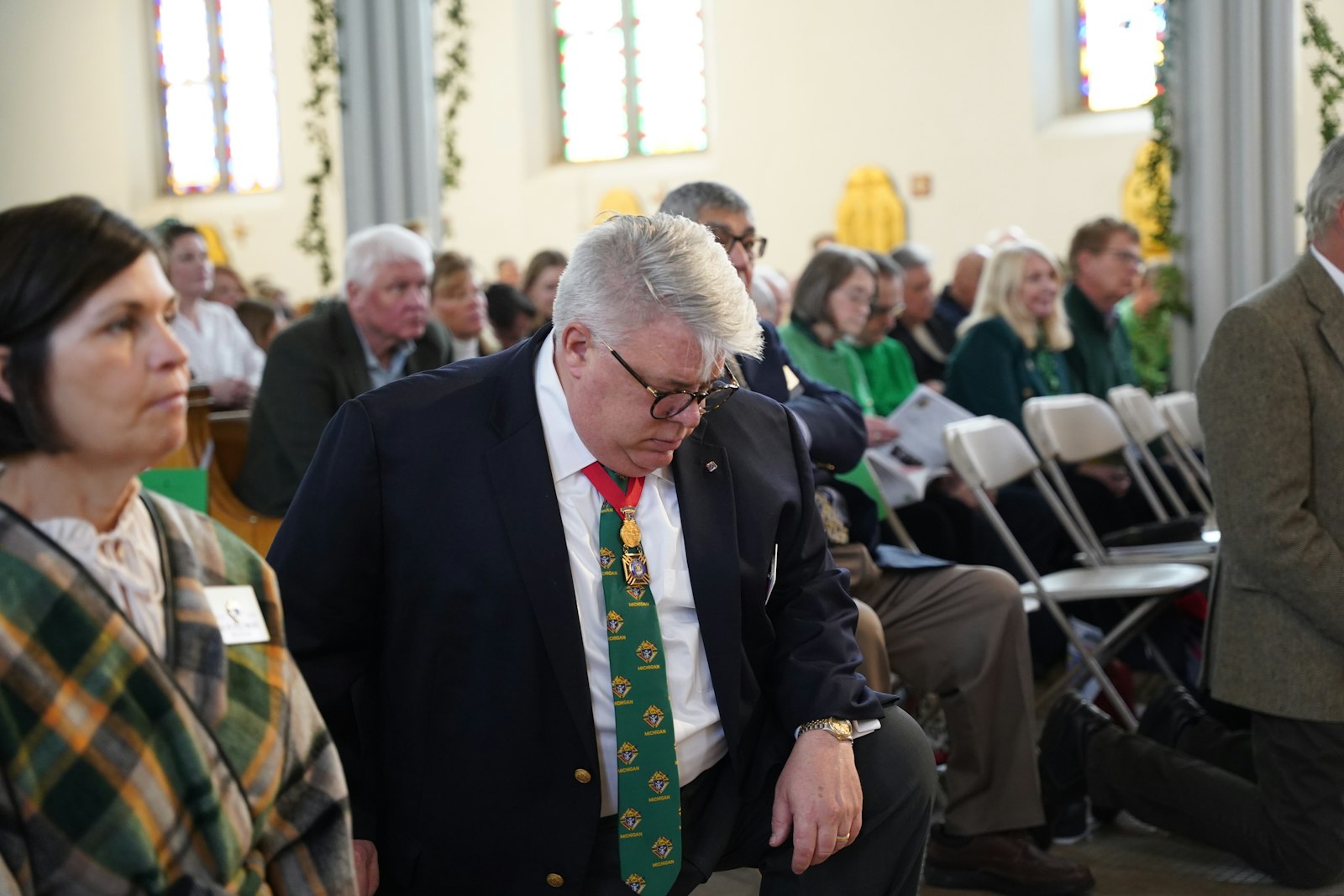 Christopher Kolomjec, state deputy of the Michigan Knights of Columbus, kneels before the Blessed Sacrament at Most Holy Trinity Parish during the St. Patrick's Day Mass. The Mass involves many fraternal organizations around the state, including the Knights of Columbus, the Ancient Order of Hibernians and the United Irish Societies.