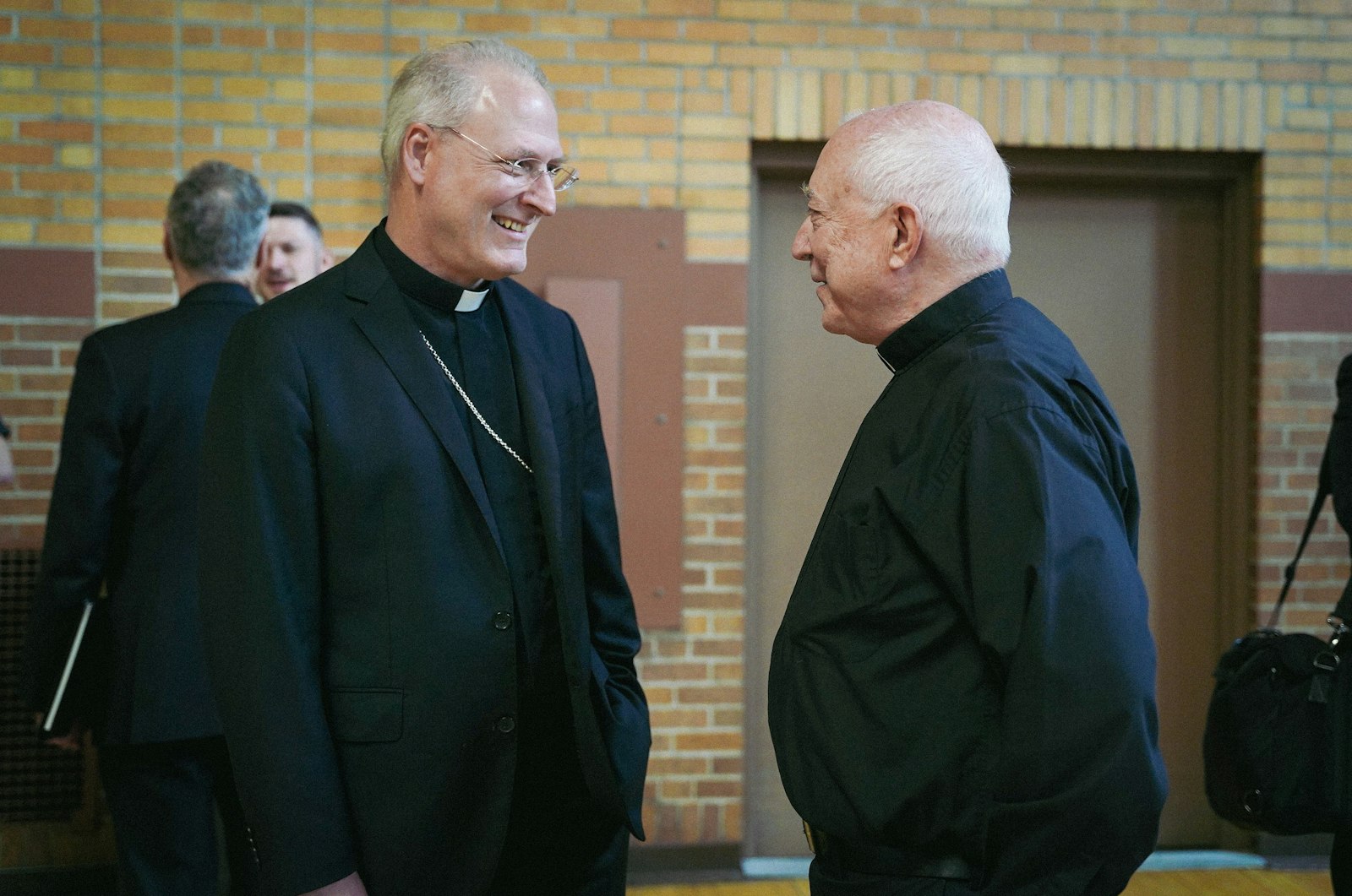 Archbishop Paul F. Russell, left, talks with Fr. Ed Zaorski, pastor of St. James Parish in Novi, during a meet-and-greet with members of the Detroit presbyterate May 23. Archbishop Russell and Fr. Zaorski have known each other since they were both teenagers working for the Archdiocese of Detroit's CYO camp in Port Sanilac. (Valaurian Waller | Detroit Catholic)