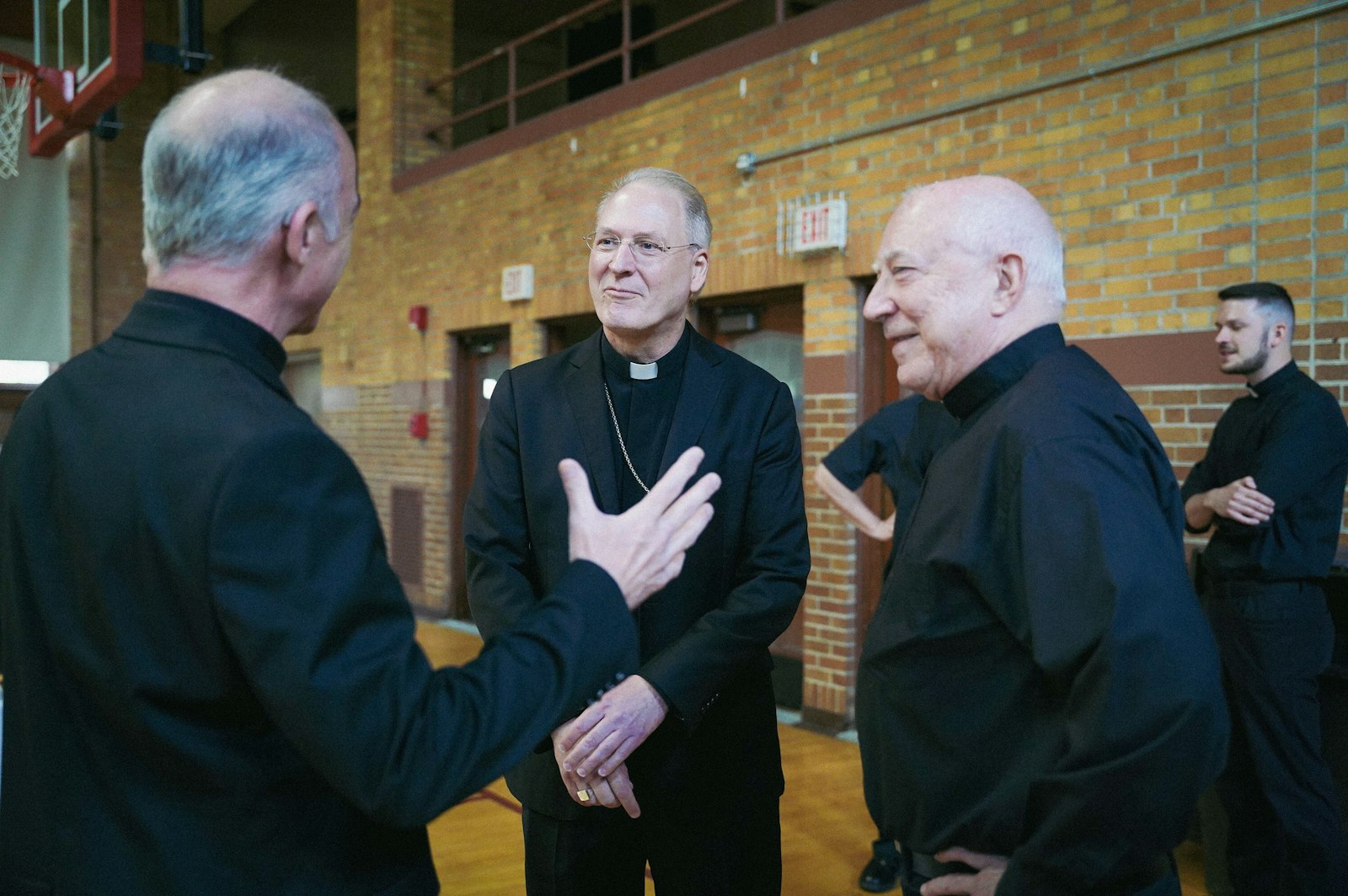 Archbishop Russell speaks with priests of the Archdiocese of Detroit at Sacred Heart Major Seminary after being introduced as Detroit's newest auxiliary bishop. Over the years, Archbishop Russell has developed friendships with a number of Detroit priests, having returned to Michigan often during his travels to care for his family back home.