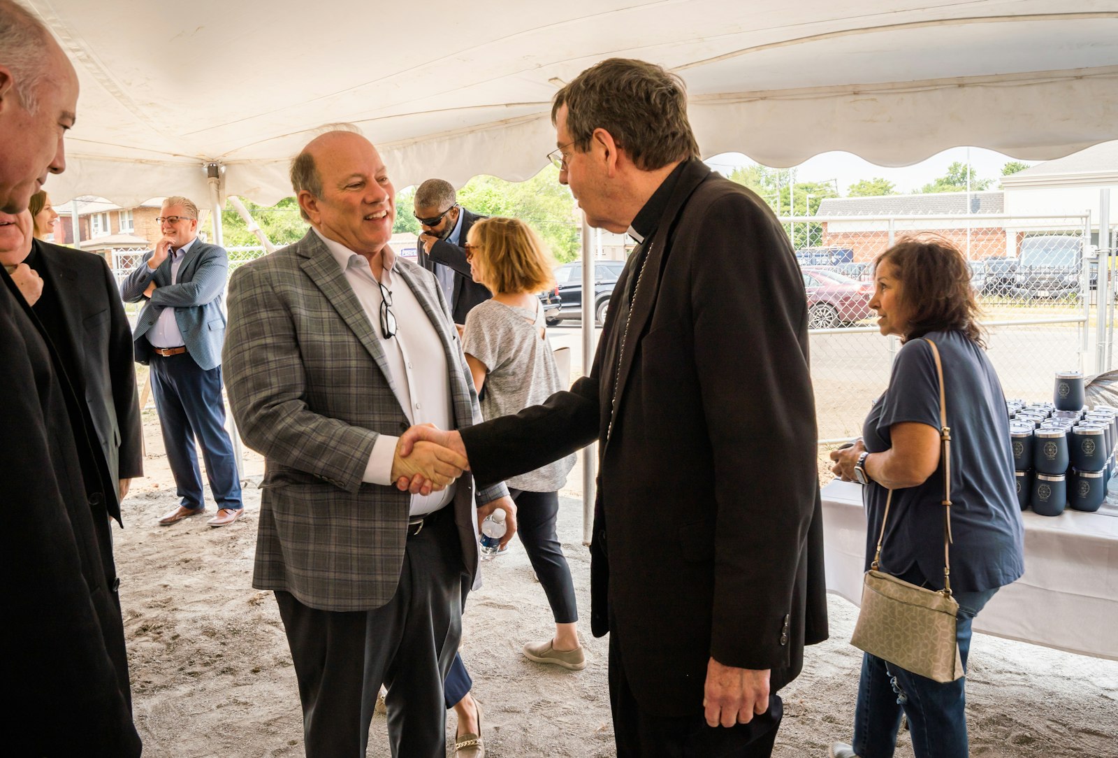 Detroit Mayor Mike Duggan shakes hands with Archbishop Allen H. Vigneron after the groundbreaking ceremony. The mayor lauded the archbishop and the Archdiocese of Detroit for its commitment to the city, which has made strides in recent years to bring affordable dwellings to the city's downtown, Midtown and neighborhoods.
