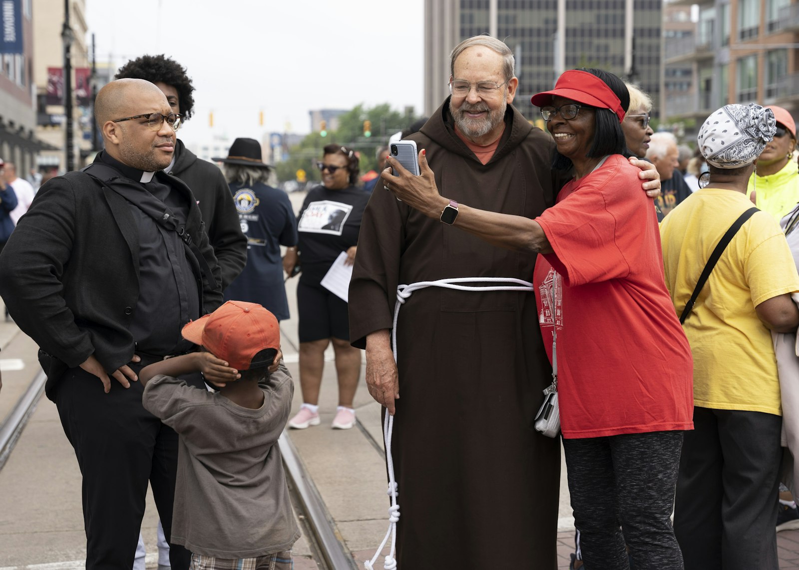 Several Catholics led by Msgr. Chuck Kosanke first gathered down the street at the former St. Patrick’s Church before joining the rest of the crowd. At left is Fr. John McKenzie, along with Capuchin Fr. David Preuss.