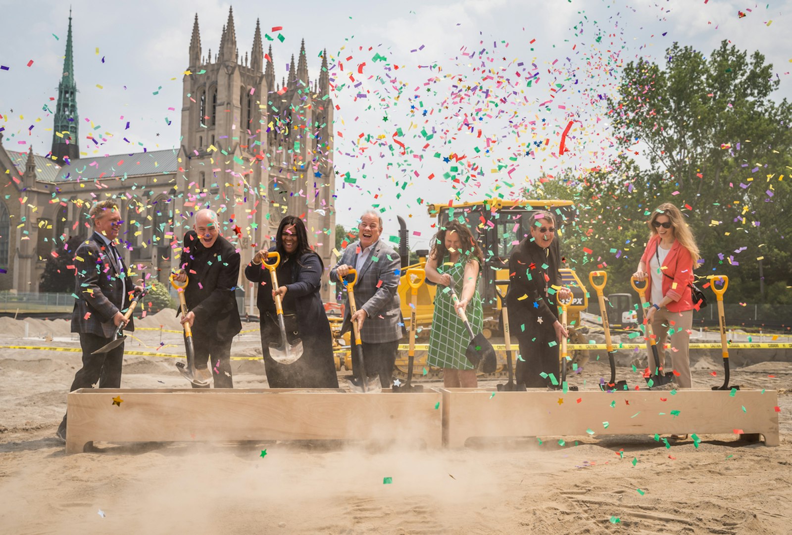 Left to right, Van Fox, president of MHT Housing, Inc.; Fr. J.J. Mech, rector of the Cathedral of the Most Blessed Sacrament; Felicia Burris, HCV program manager for the Detroit Housing Commission; Detroit Mayor Mike Duggan; Kelly Rose, chief housing solutions officer for the Michigan State Housing Development Authority; Detroit Archbishop Allen H. Vigneron; and Alison Anderson of City Real Estate Advisors smile during the groundbreaking ceremony for the new Cathedral Arts Apartments, a 53-unit affordable housing complex that will be build on land across Woodward Avenue owned by the Cathedral of the Most Blessed Sacrament. The project is a joint venture of the cathedral and MHT Housing, Inc., to bring opportunities to the neighborhood's low-income residents. (Valaurian Waller | Detroit Catholic)