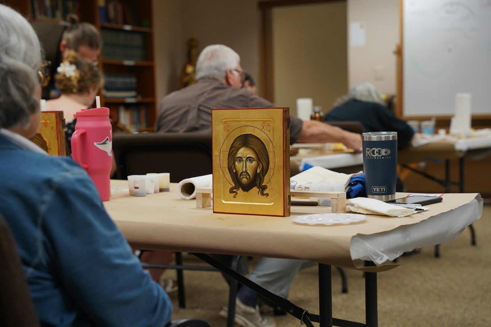 An icon of Christ the Redeemer painted by a retreat participant sits on a table as Bro. Skowron teaches on the final day of the workshop, July 12.