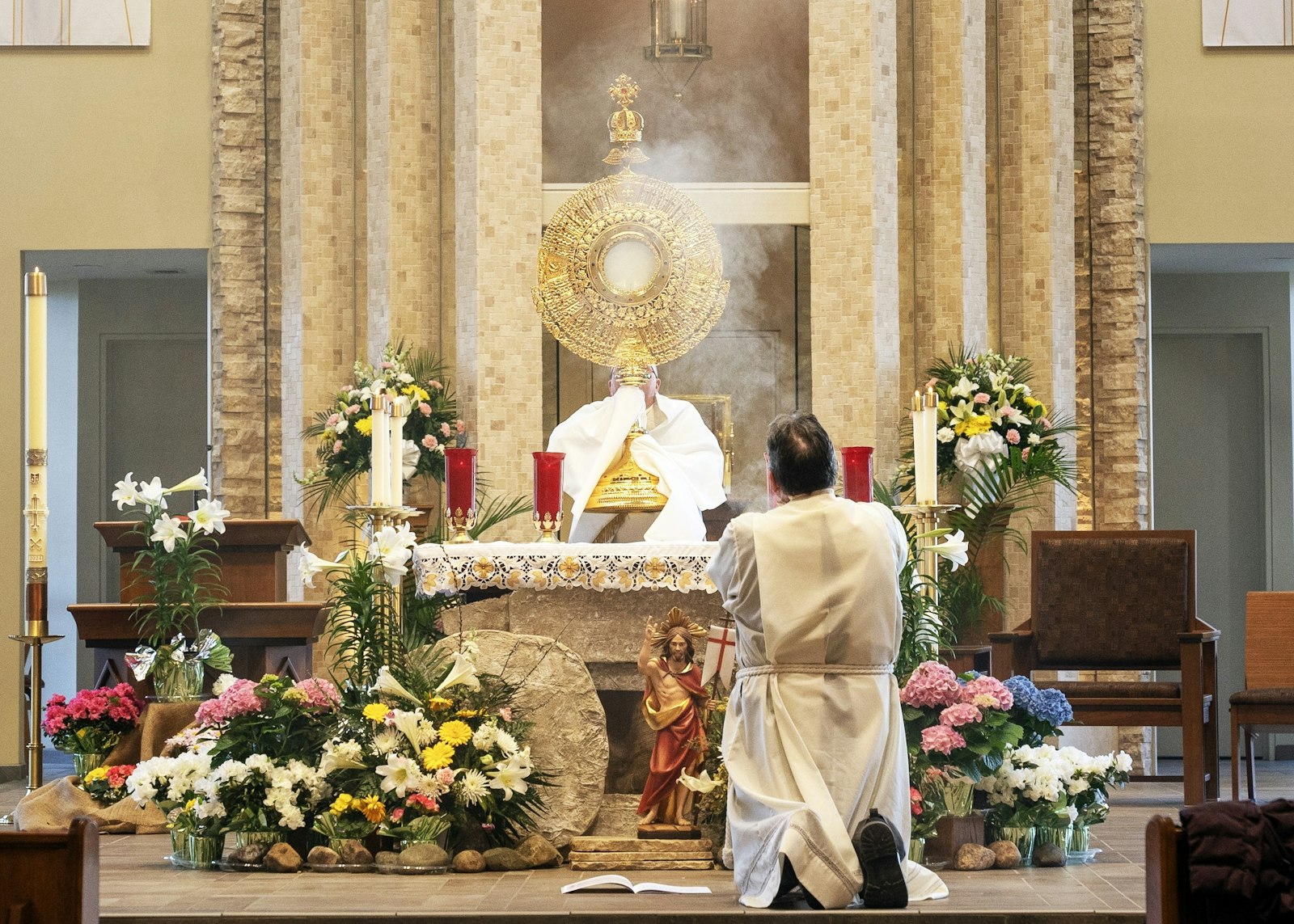 Catholics adore Jesus in the Blessed Sacrament, housed in a five-foot monstrance on the altar of St. Kieran Parish. Bishop Robert J. Fisher, moderator of the Archdiocese of Detroit's Northeast Region, celebrated Mass for attendees.