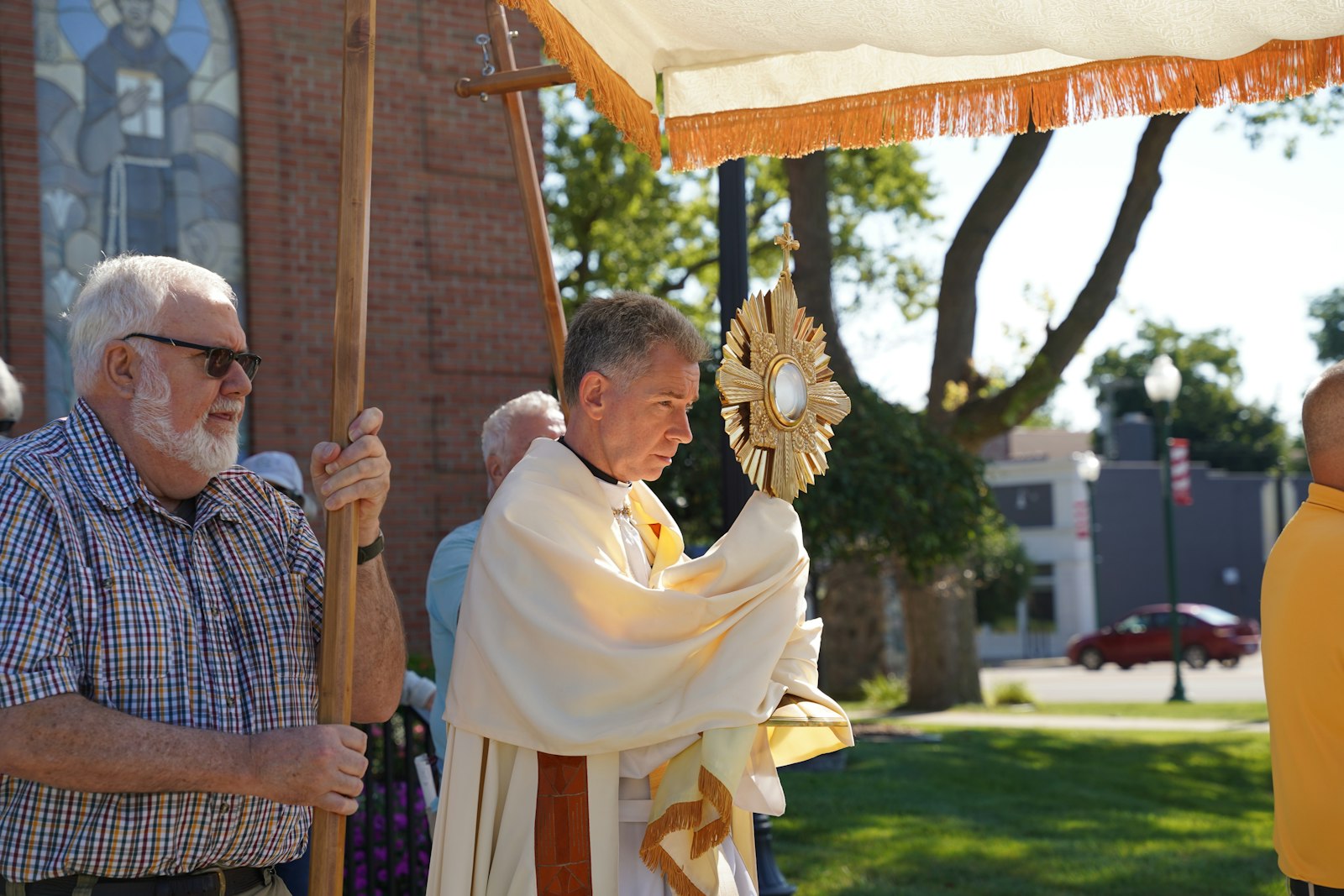 Fr. David Burgard of St. Mary Parish in Monroe leads the Eucharistic procession to begin the "Rise from the Ashes" pilgrimage on July 19. This year's pilgrimage also includes Eucharistic processions in Wyandotte and Detroit.