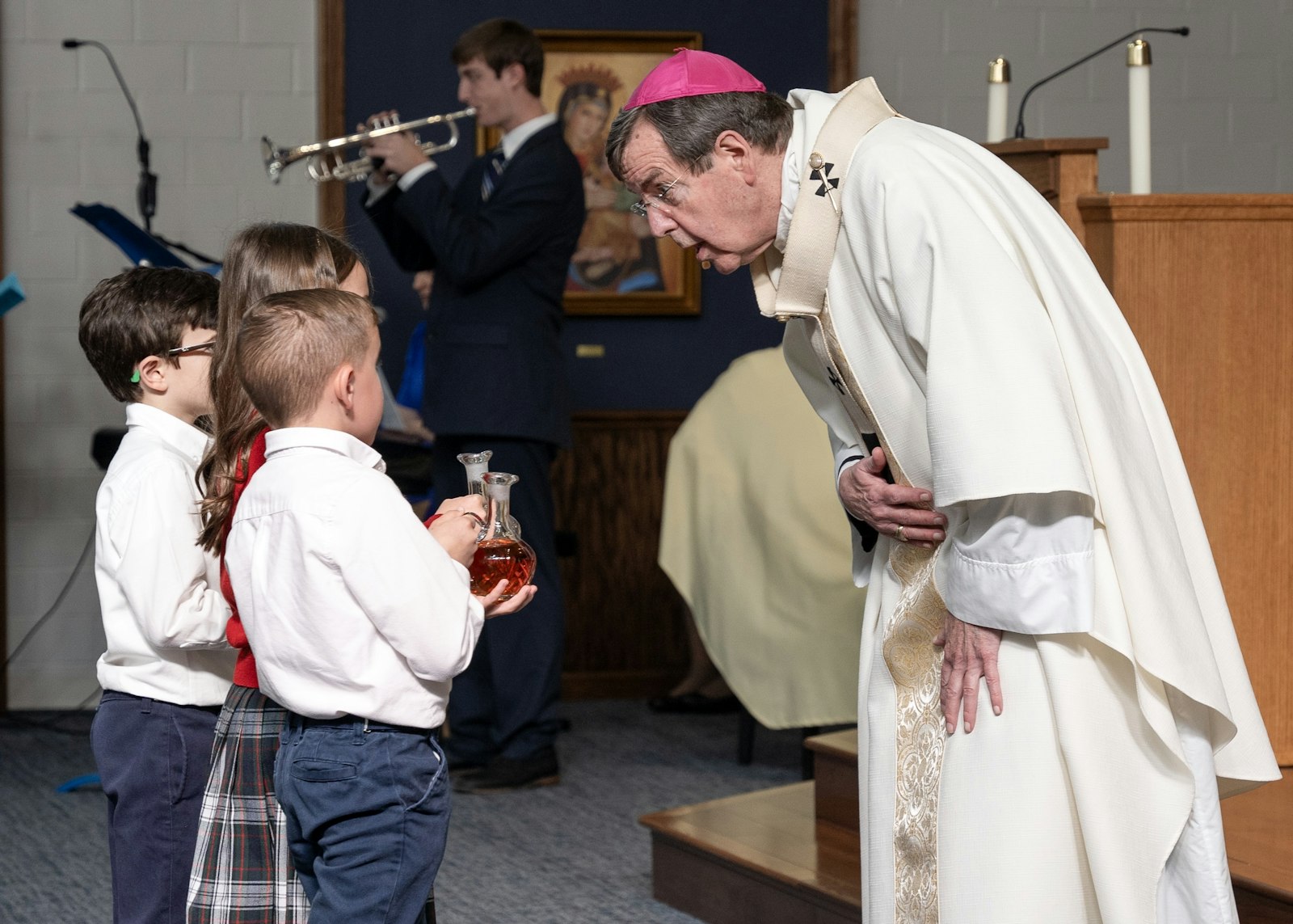 St. Mary School second-graders present the gifts of the altar to Archbishop Allen H. Vigneron during the dedication Mass in the school's new chapel.