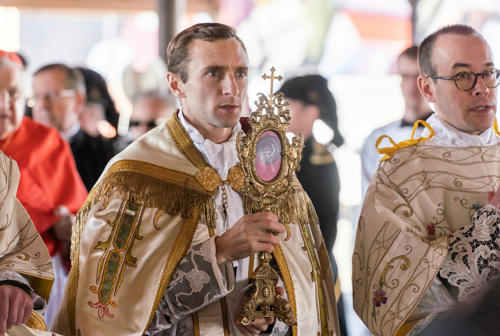 Canon ﻿Jean-Baptiste Commins, ICKSP, rector of St. Joseph Shrine, carries a relic of St. Joseph for veneration during a public procession through Detroit's Eastern Market.