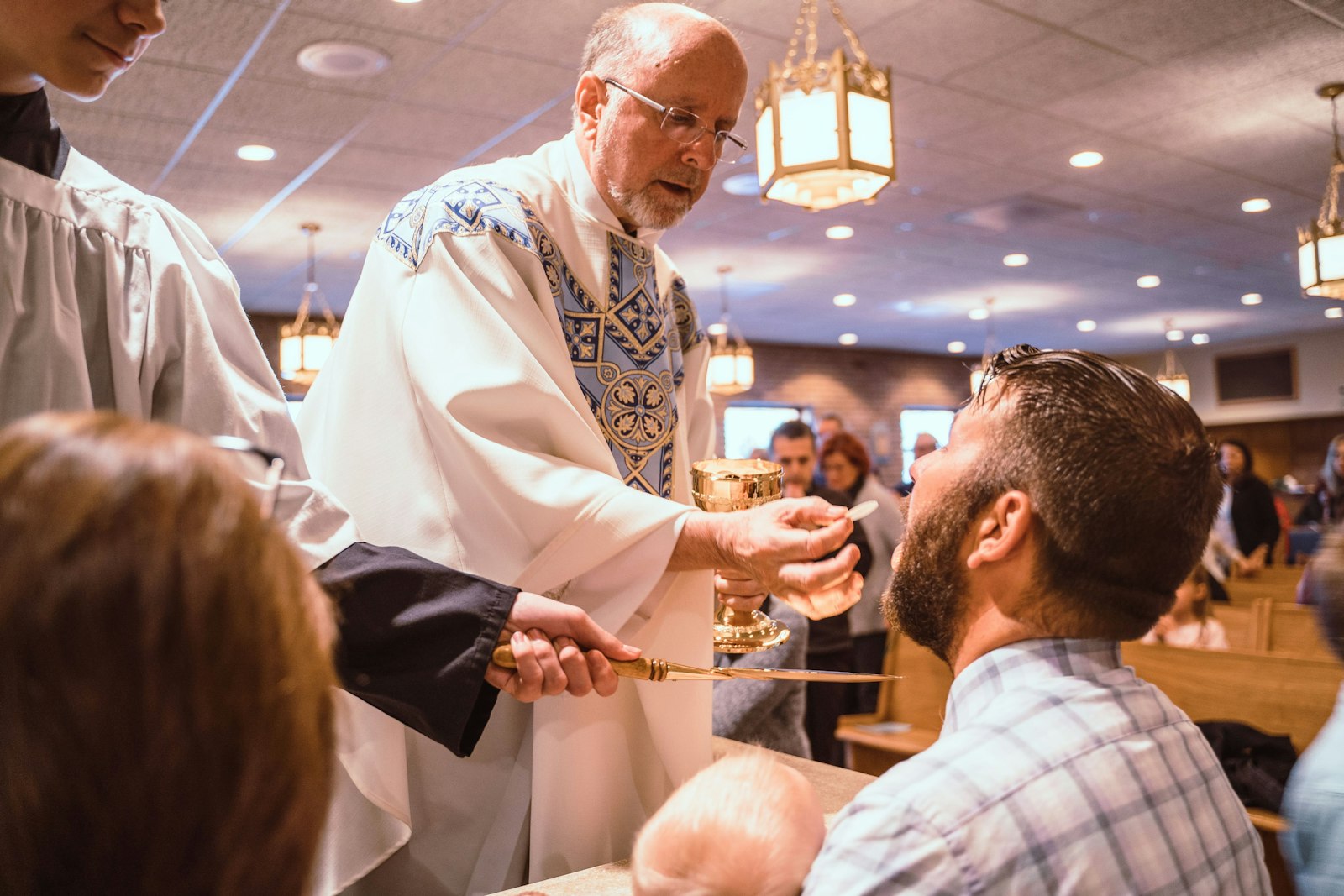 Fr. John Hedges offers Communion to a man at the Our Lady of Fatima Shrine in Riverview in this file photo. The U.S. Conference of Catholic Bishops will sponsor a three-year Eucharistic Revival starting this summer, an effort to bolster Catholics' faith in the Real Presence of Jesus in the Eucharist.