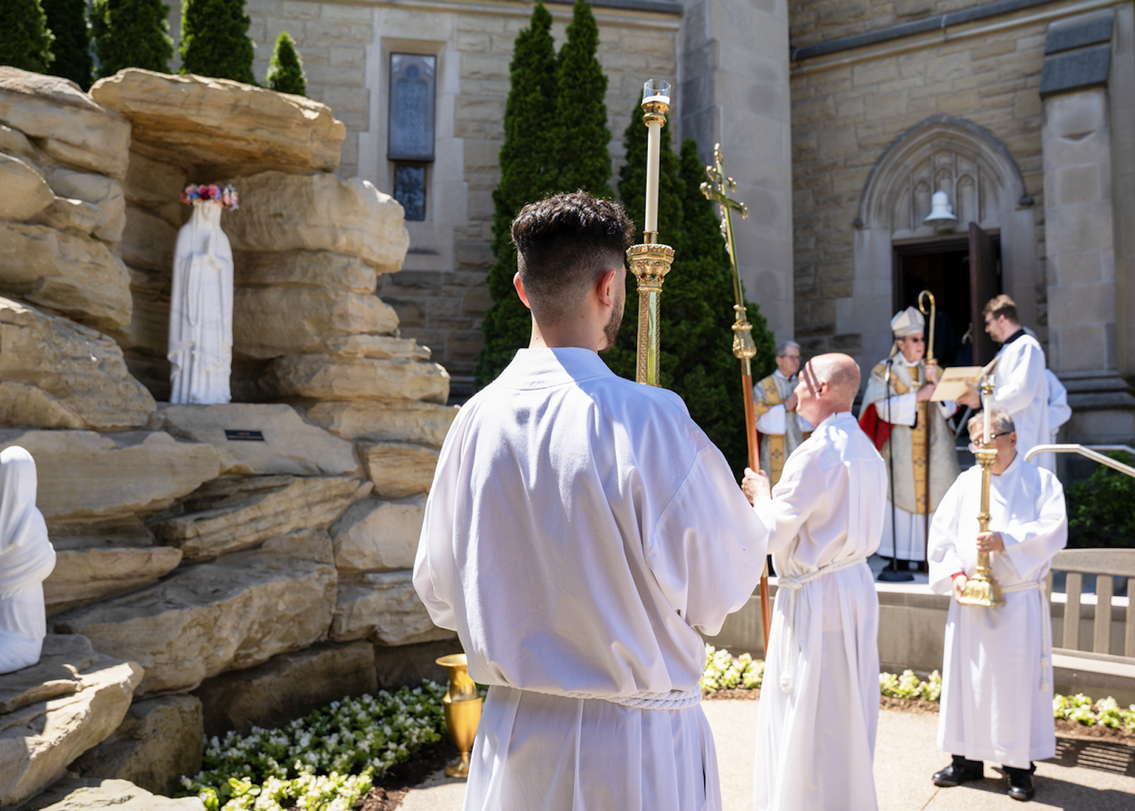 Archbishop Vigneron, right, dedicates a new outdoor grotto to Our Lady of Lourdes at the Cathedral of the Most Blessed Sacrament on Mother’s Day, May 12, 2024. The dedication is the fulfillment of a promise the archbishop made four years earlier during the COVID-19 crisis to entrust the Archdiocese of Detroit to the care of Our Lady during the worst days of the pandemic. (Gabriella Patti | Detroit Catholic)