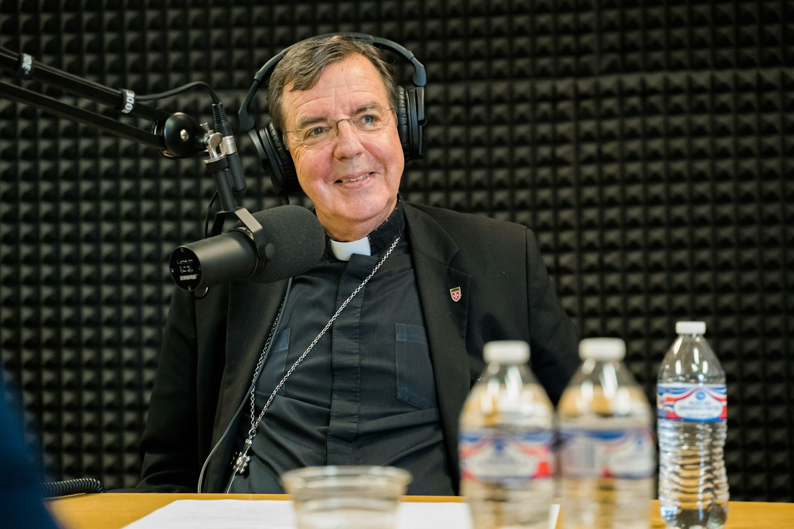 Archbishop Allen H. Vigneron smiles during a recording of the first episode of the “Eyes on Jesus” podcast in September 2019. The monthly podcast series features the archbishop and co-hosts talking about life, evangelization and timely news topics, as well as questions from listeners. (Valaurian Waller | Detroit Catholic)