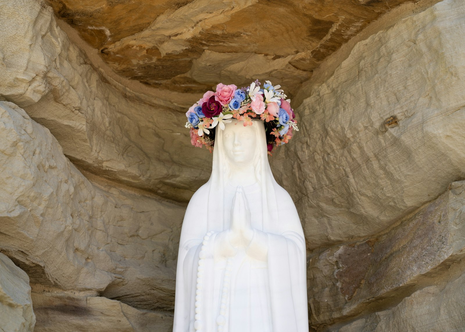 Archbishop Vigneron instructed that the alabaster statue of Our Lady of Lourdes be reflective of St. Bernadette Soubirous's description of her face.