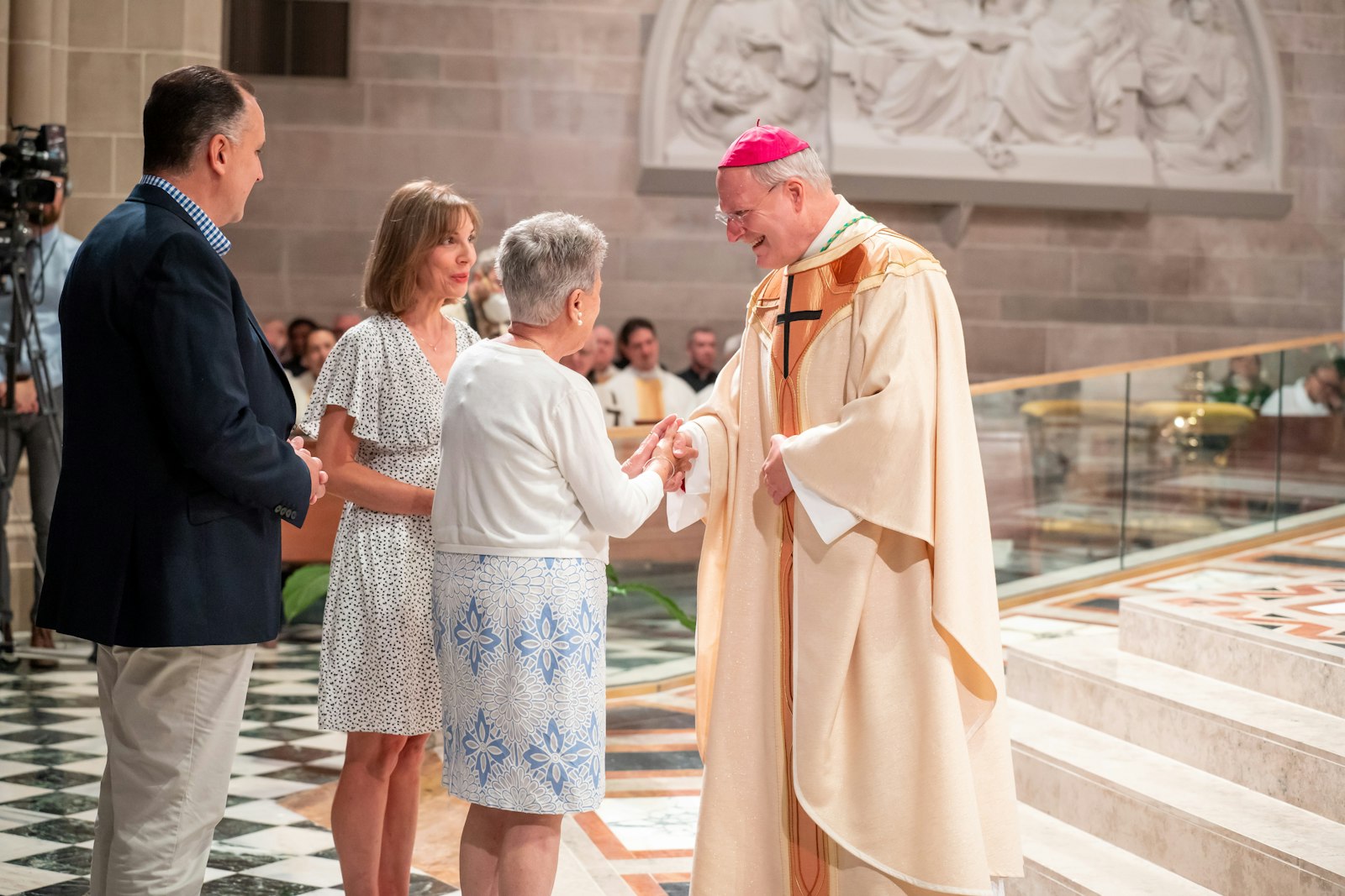 Archbishop Russell greets staff from the Archdiocese of Detroit during his welcome and inauguration Mass. Archbishop Russell said he looks forward to working with Archbishop Allen H. Vigneron of Detroit and serving in whatever capacity Archbishop Vigneron may need him.