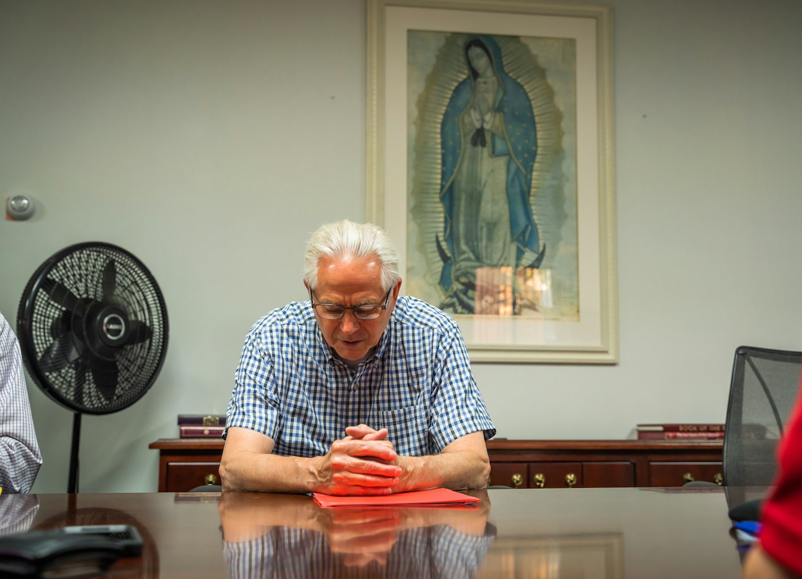 An "ultreya" participant prays during a circle prayer at St. Benedict Parish in Waterford. Cursillo participants are encouraged to sponsor others before, during and after Cursillo weekend retreats, praying for that person and including them in regular intentions. (Valaurian Waller | Detroit Catholic)