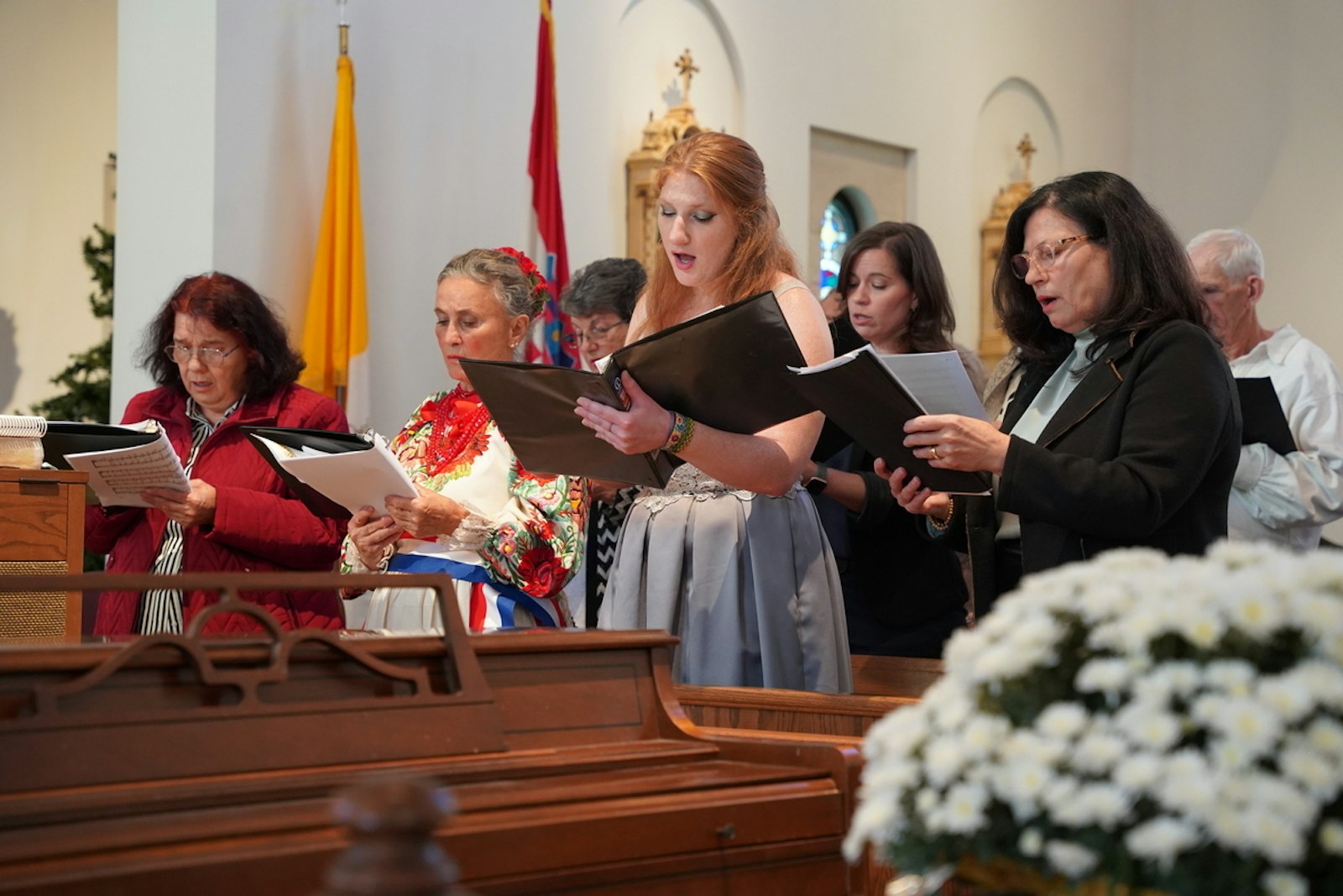 Members of the parish choir sing during the 100th anniversary Mass on Oct. 19.