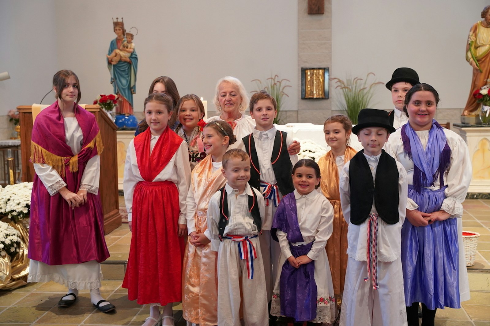 Youth from St. Lucy Croatian Parish dressed in their traditional dress, known as "Lika," during the community's 100th anniversary Mass with Detroit Archbishop Allen H. Vigneron.